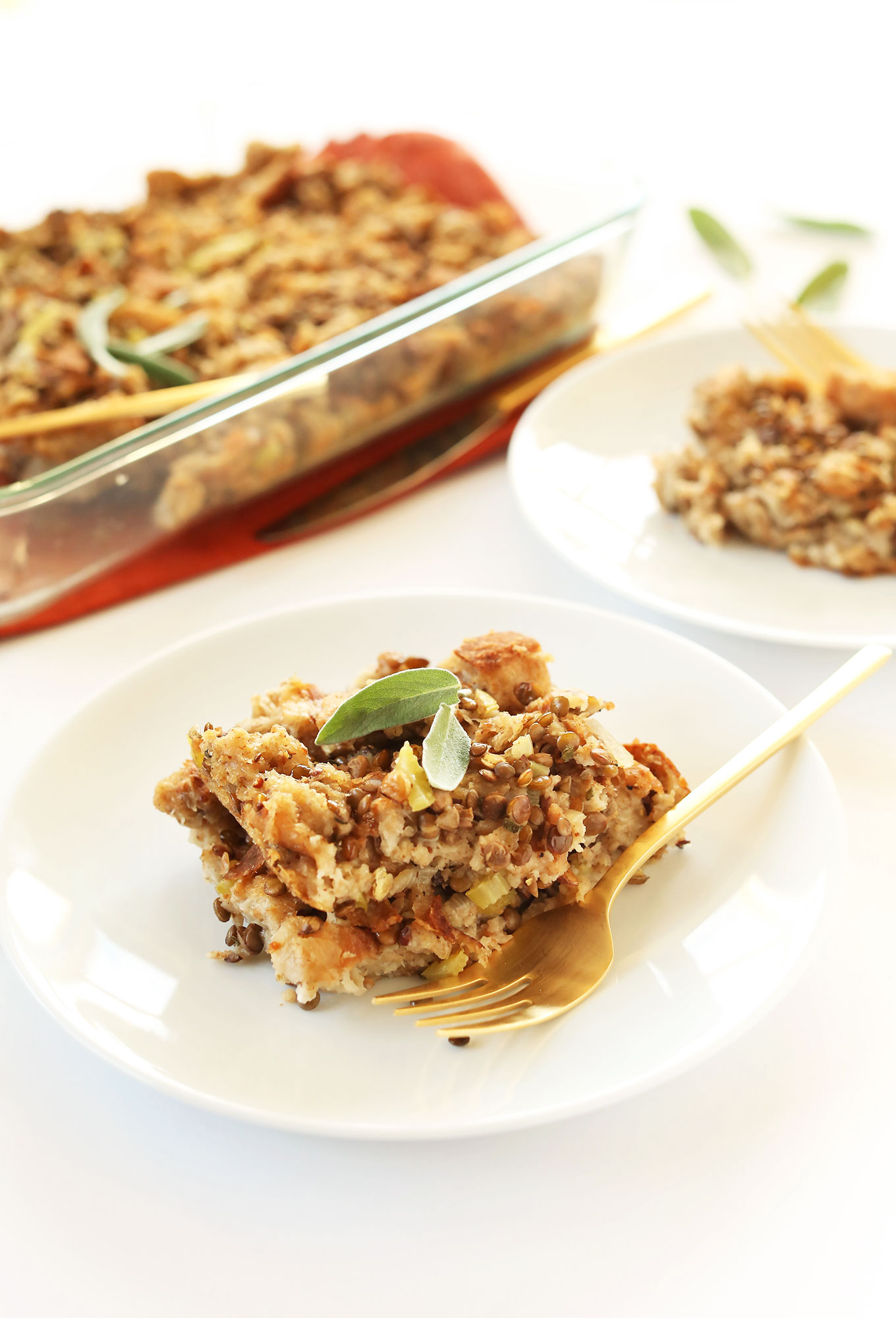 Close up shot of a plate of simple vegan stuffing topped with sage leaves