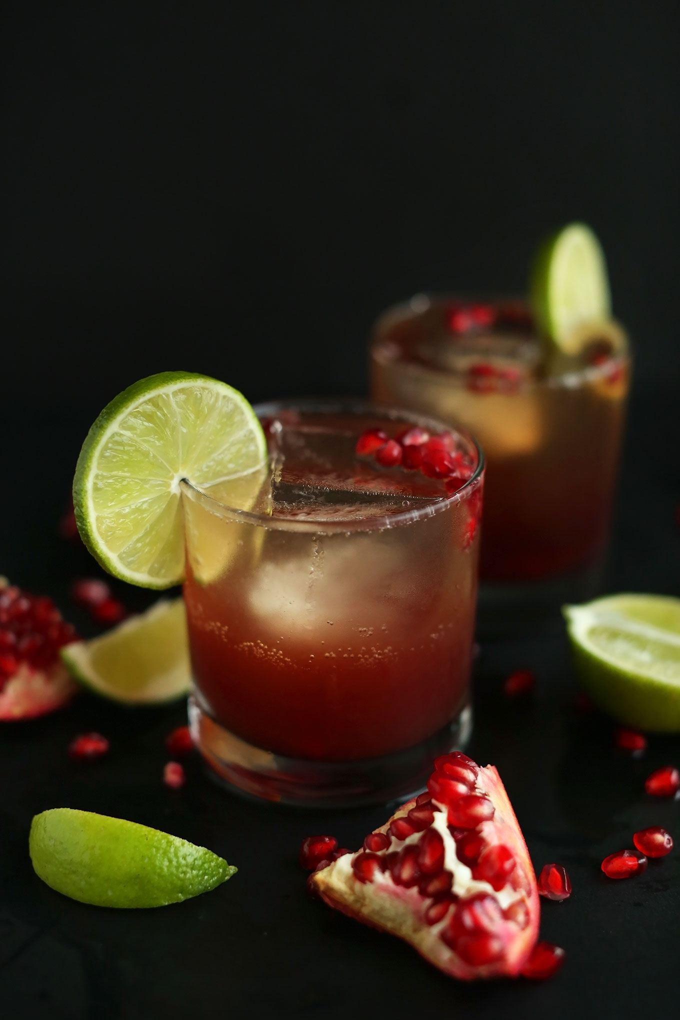 Close up shot of our Sparkling Pomegranate Margarita recipe with a lime on the rim