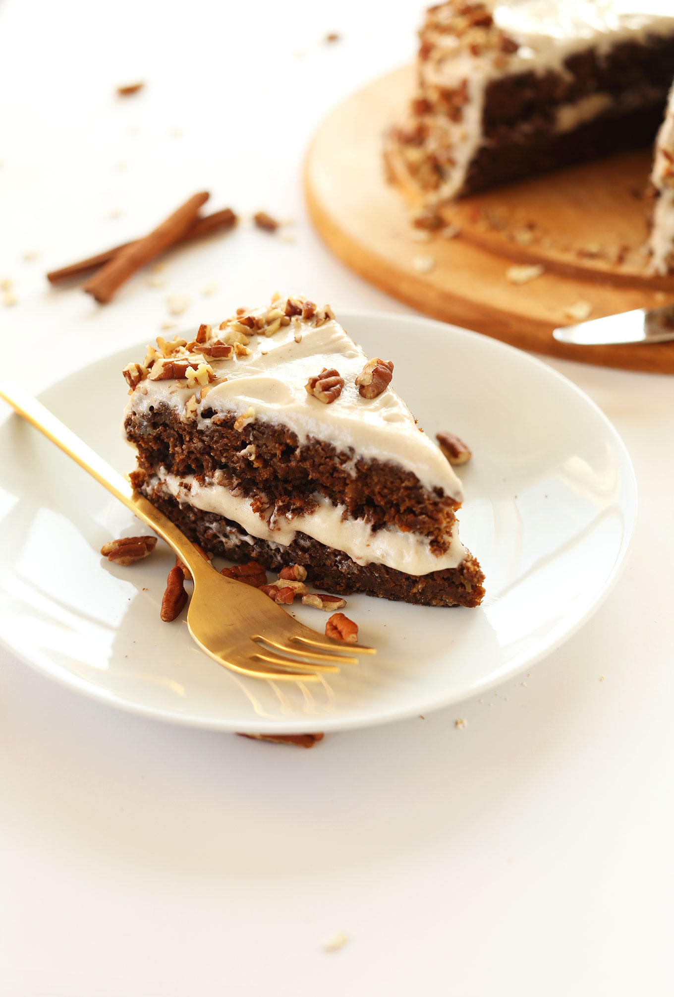 Slice of whole grain Apple Gingerbread Cake with Vegan Cream Cheese Frosting