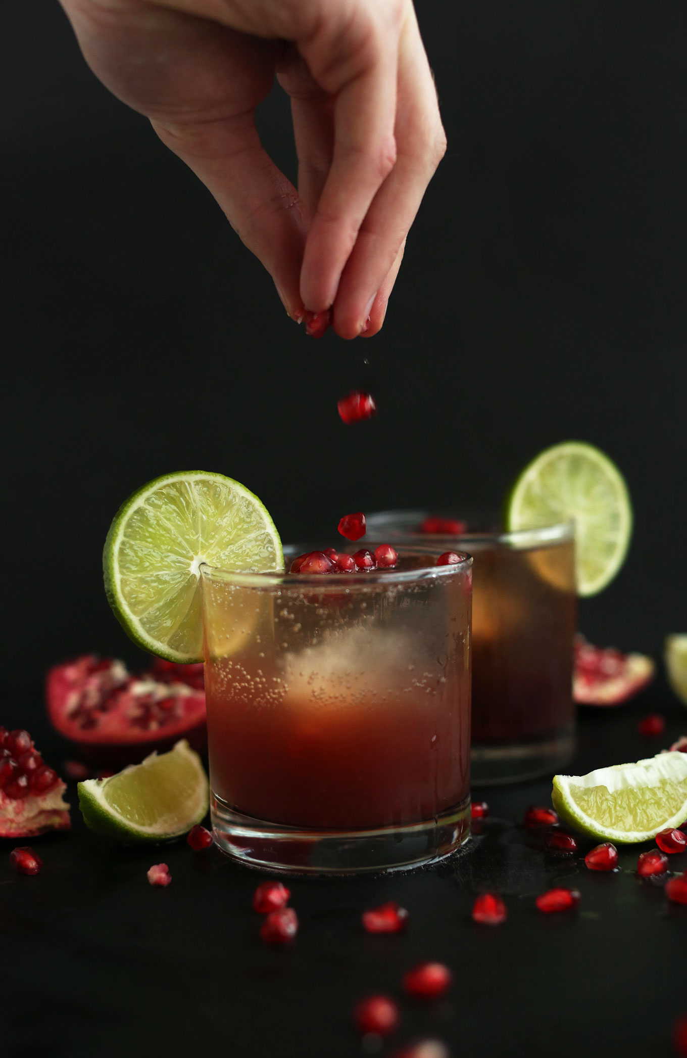 Sprinkling pomegranate arils for a homemade New Year's Eve drink