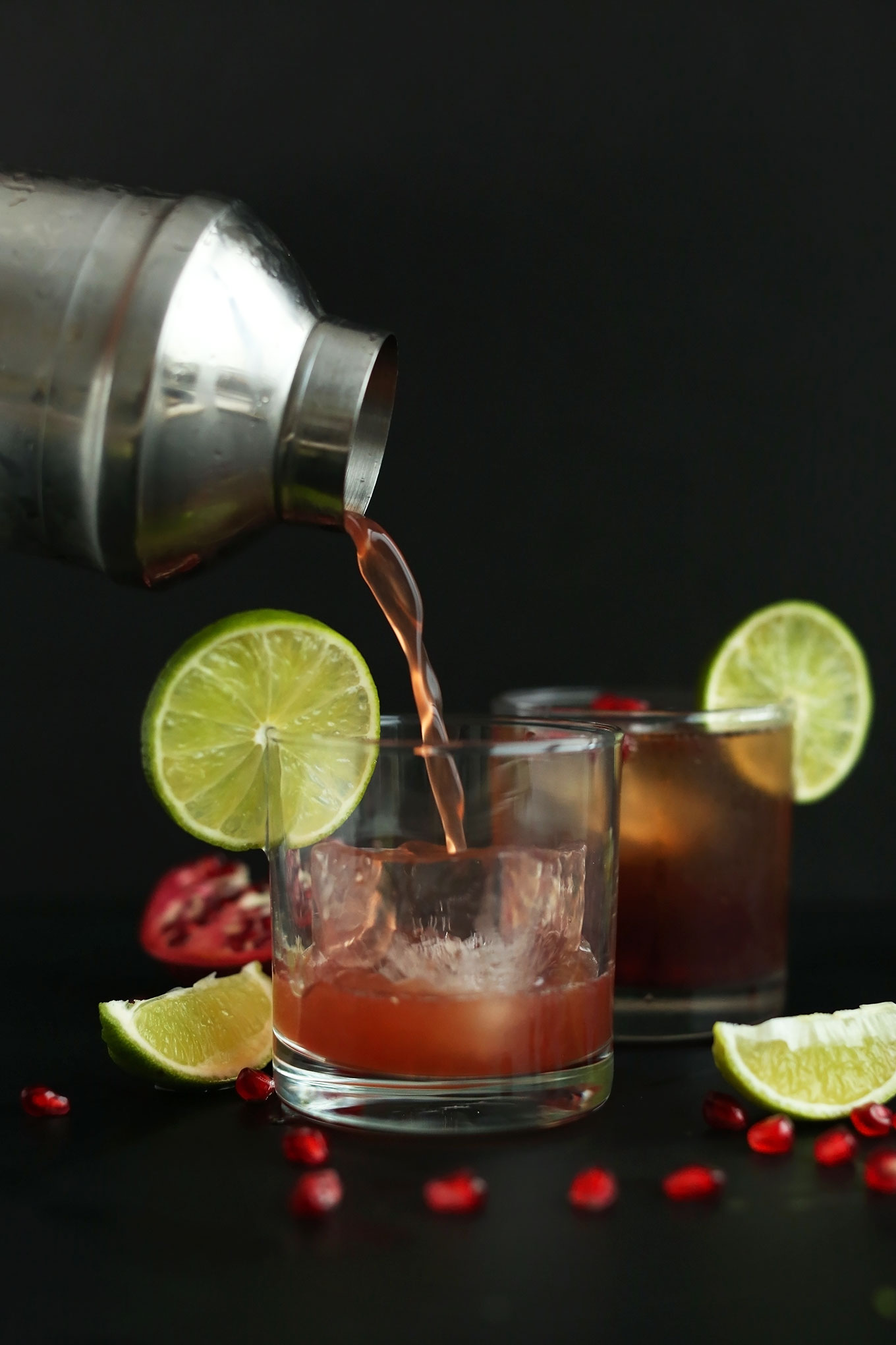 Pouring our Sparkling Pomegranate Margarita recipe over ice