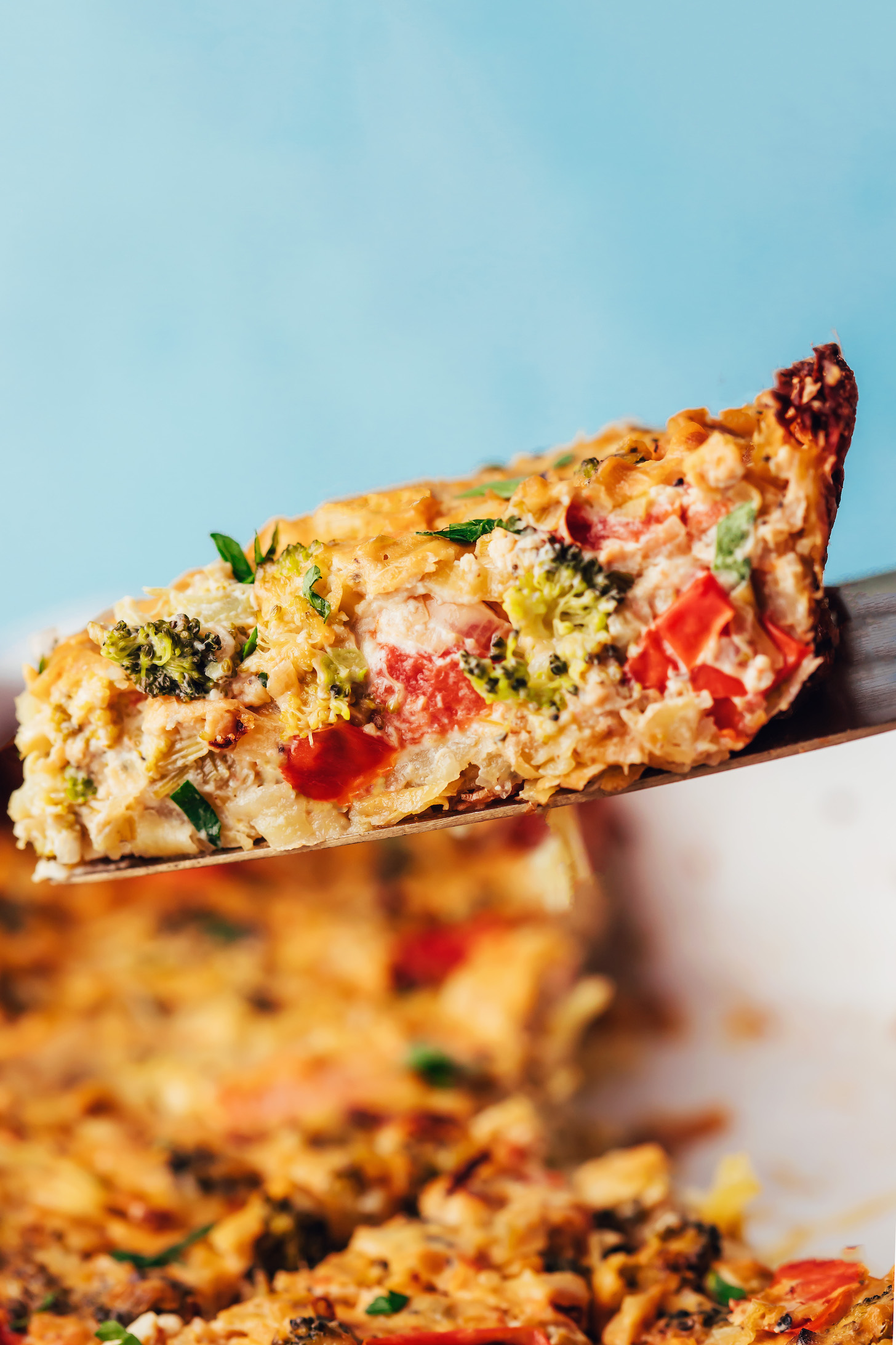 Slice of our easy vegan tofu quiche with roasted vegetables
