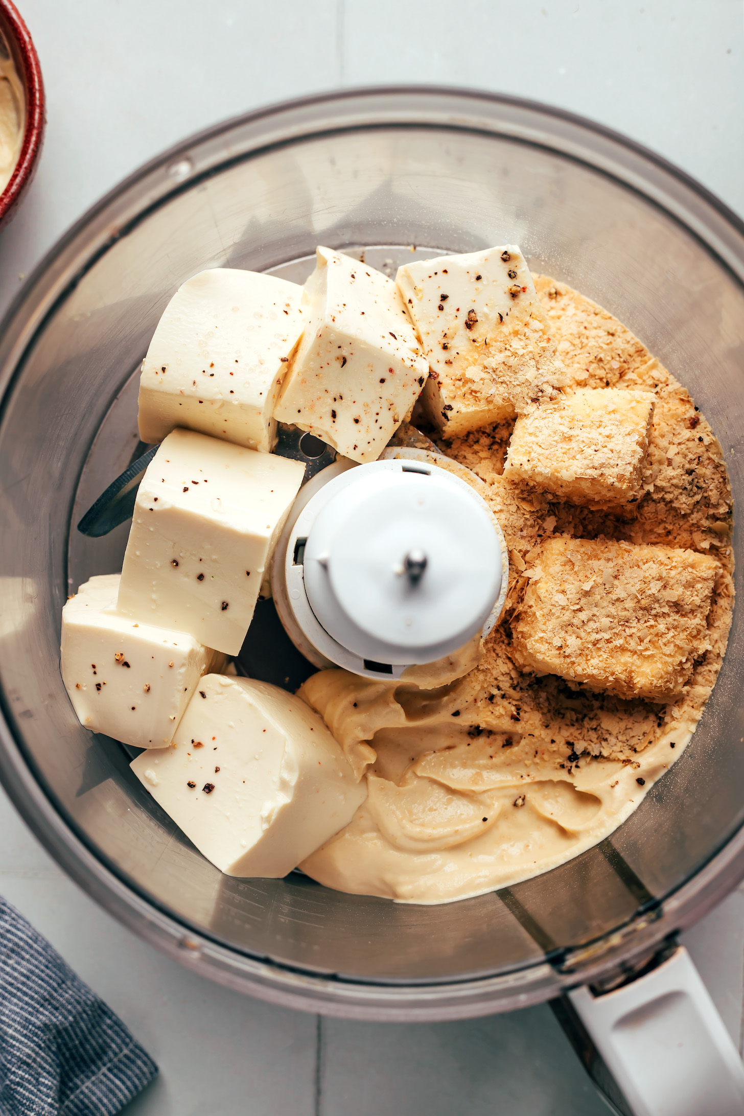 Silken tofu, nutritional yeast, hummus, salt, and pepper in a food processor to make the easiest vegan quiche filling