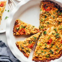 Partially sliced tofu quiche in a pie pan