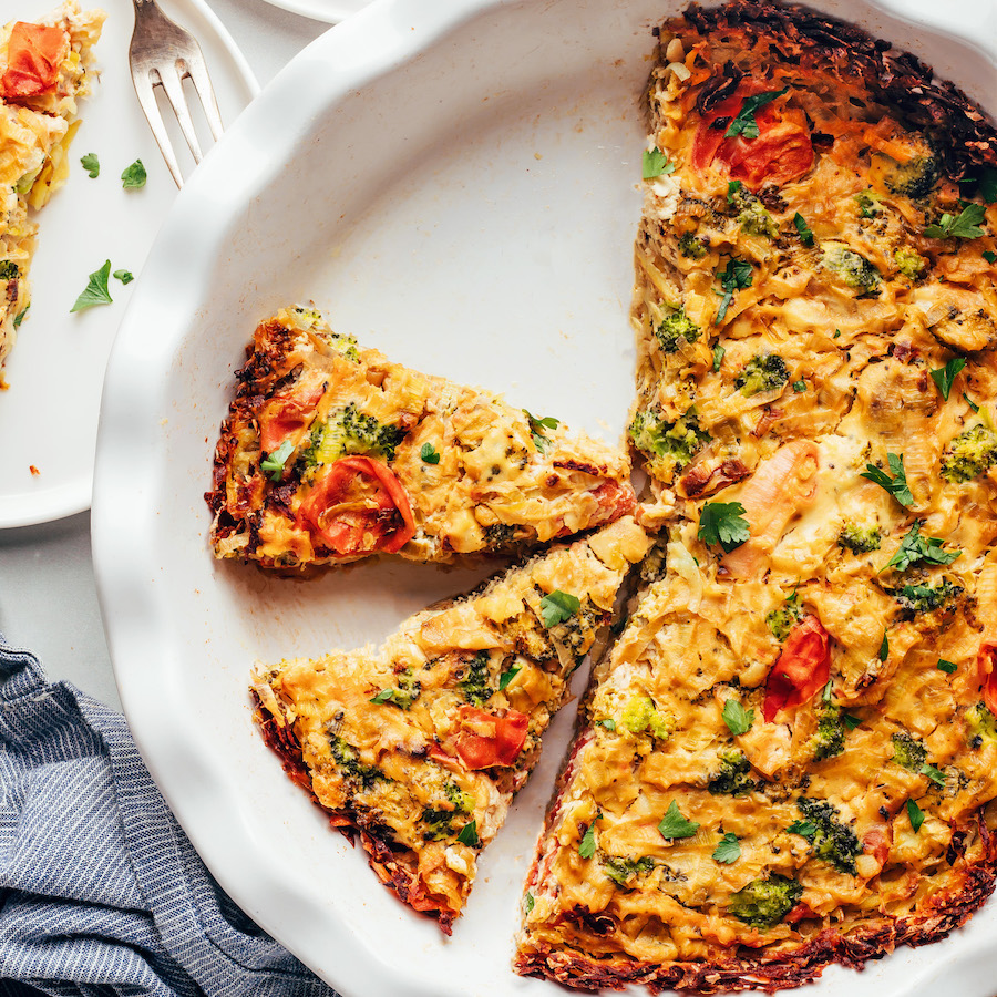 Partially sliced tofu quiche in a pie pan