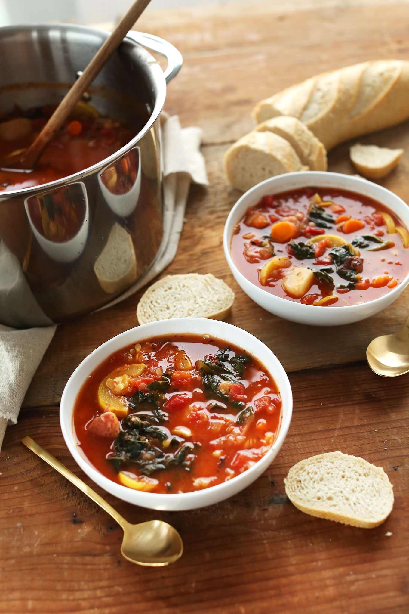 Bowls of our 1-Pot Veggie and White Bean Stew with slices of bread