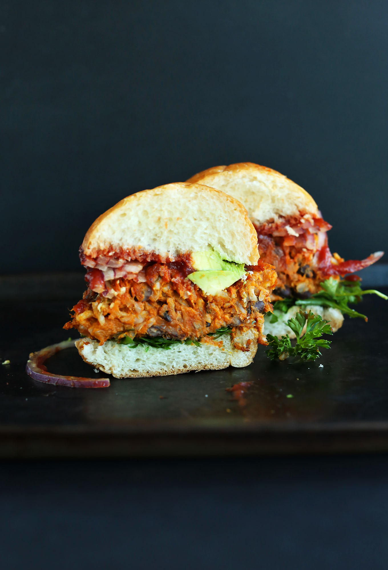 Halved Sweet Potato Black Bean Burger on a bun with vegetables