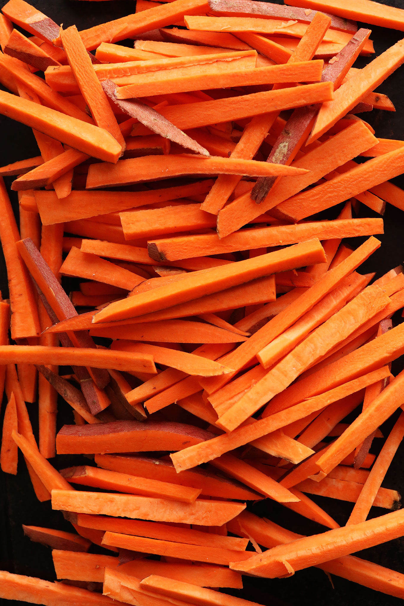 Sliced sweet potatoes for making perfectly baked Sweet Potato Fries
