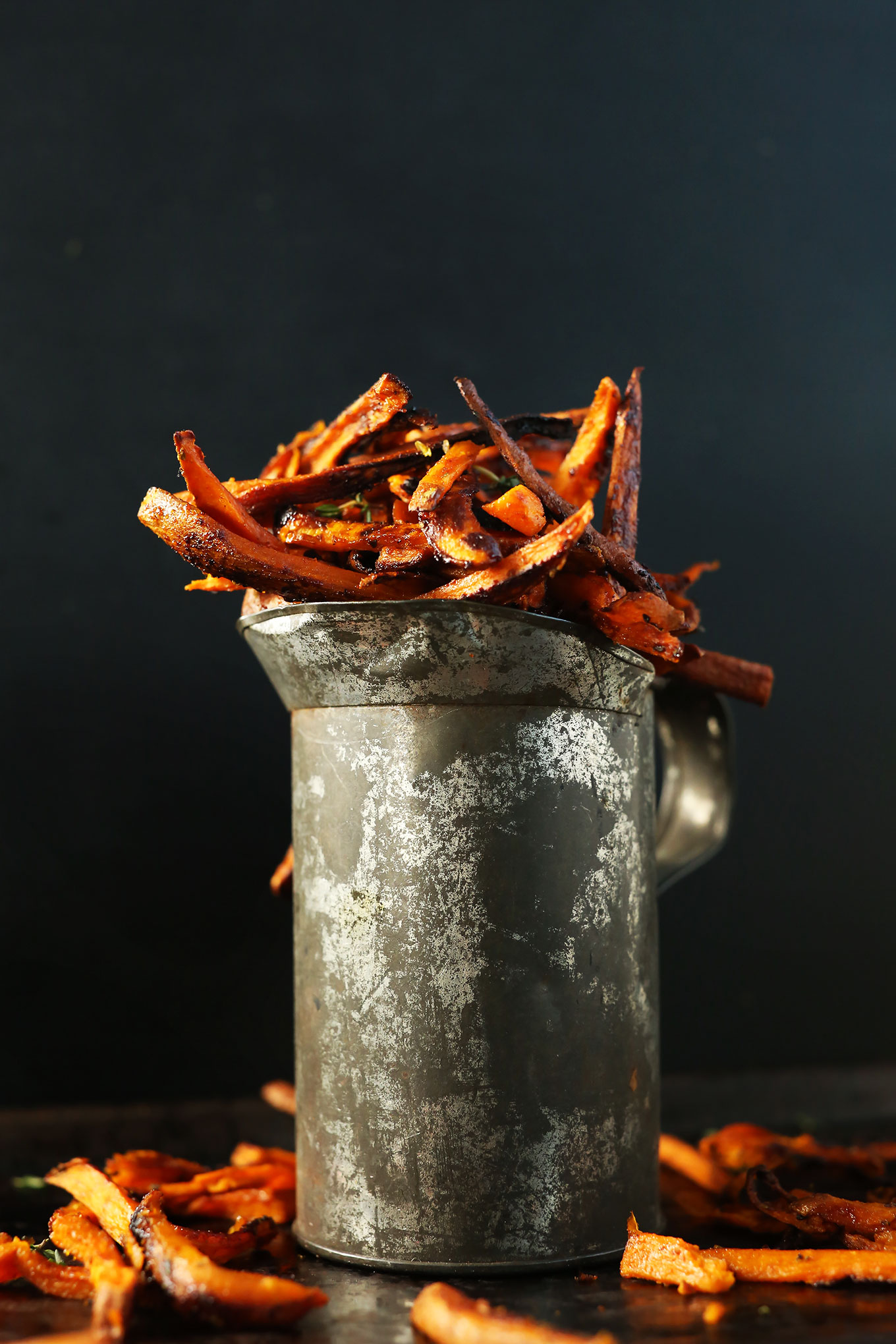 Metal pitcher filled with homemade Cajun Sweet Potato Fries