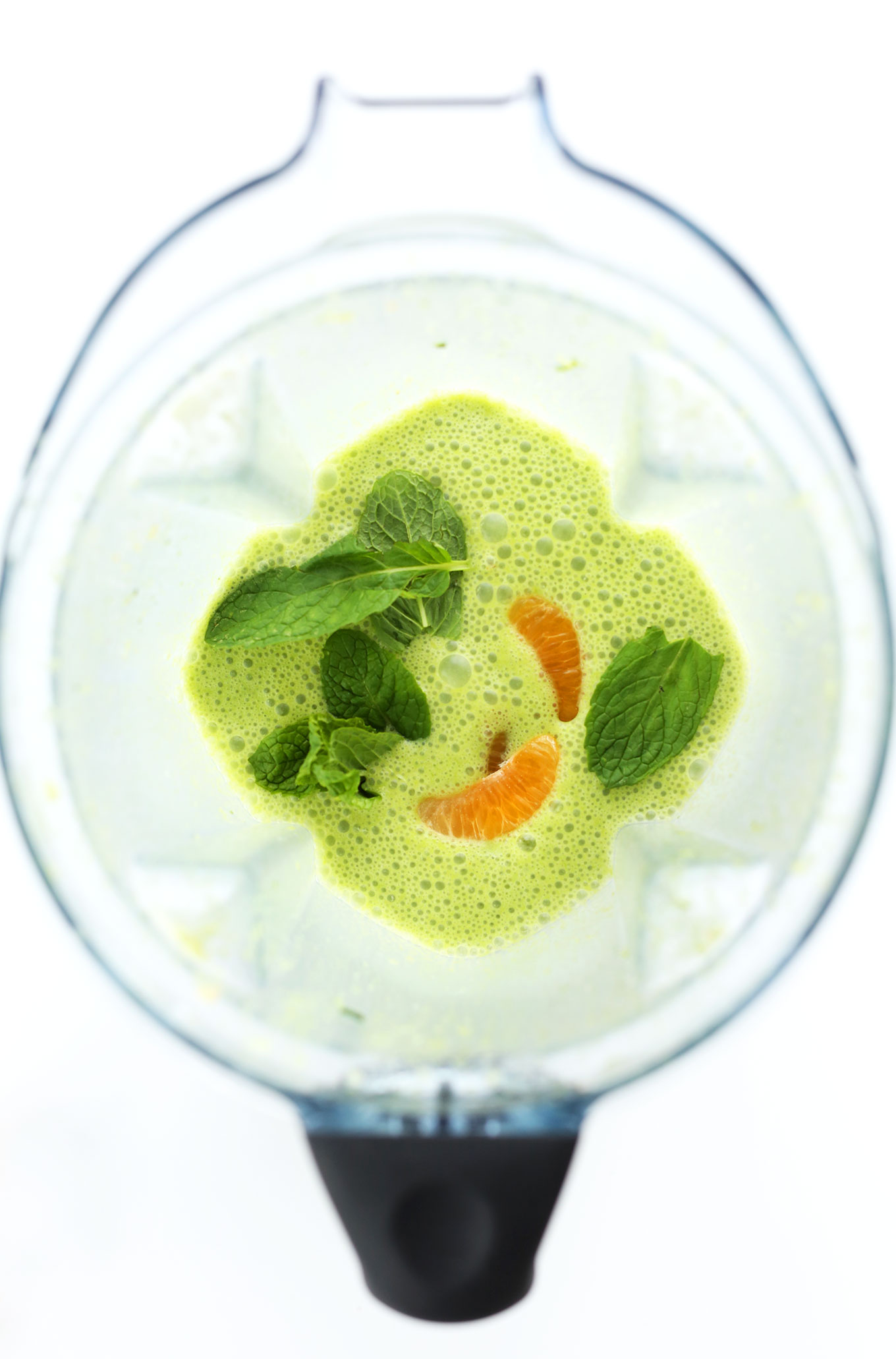 Blender filled with ingredients for making a vegan Coconut Green Smoothie