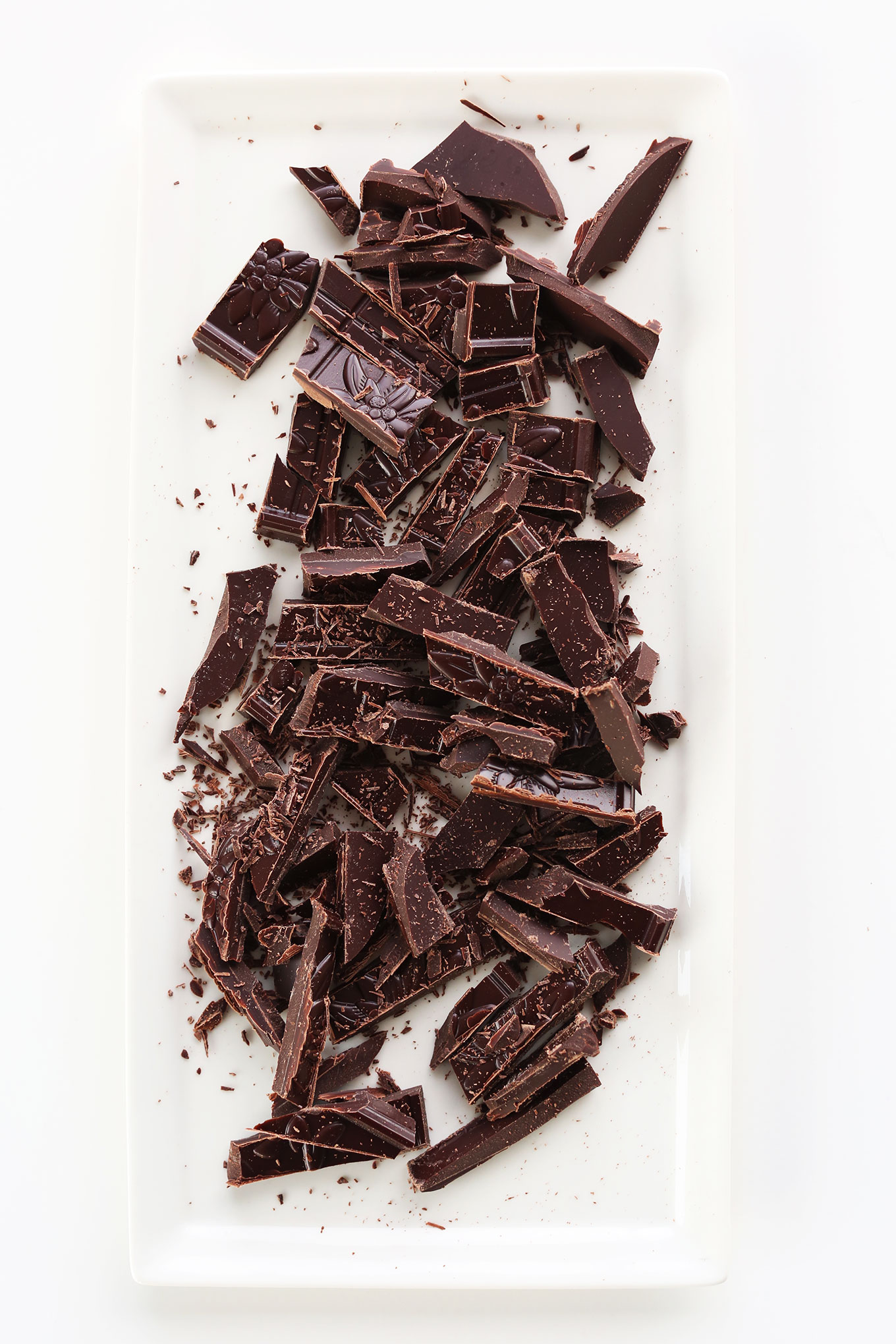 Chopped dark chocolate on a platter for making homemade vegan mousse