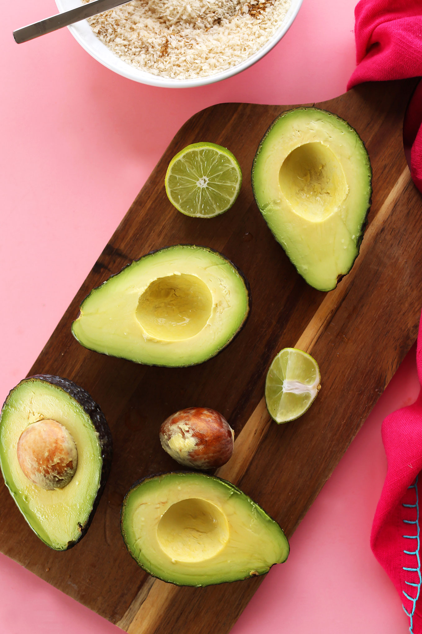 Cutting board with halved avocados and limes