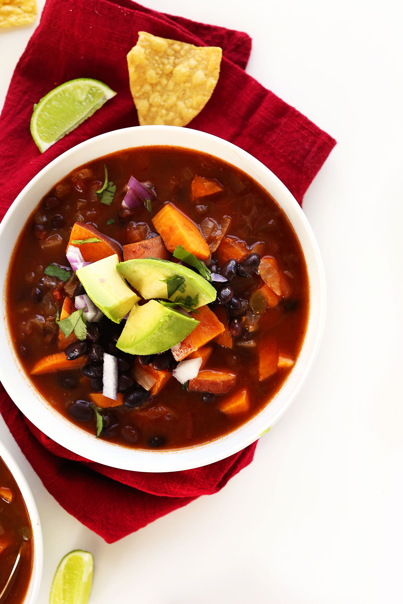 Bowl of our vegan Sweet Potato Black Bean Chili recipe topped with avocado