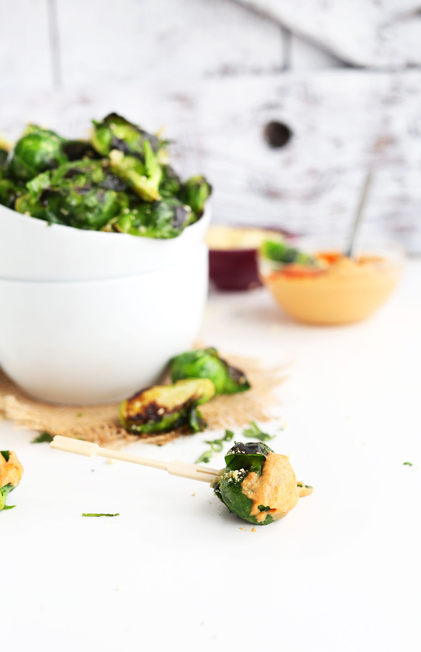 Brussels Sprout speared with a toothpick resting on a table