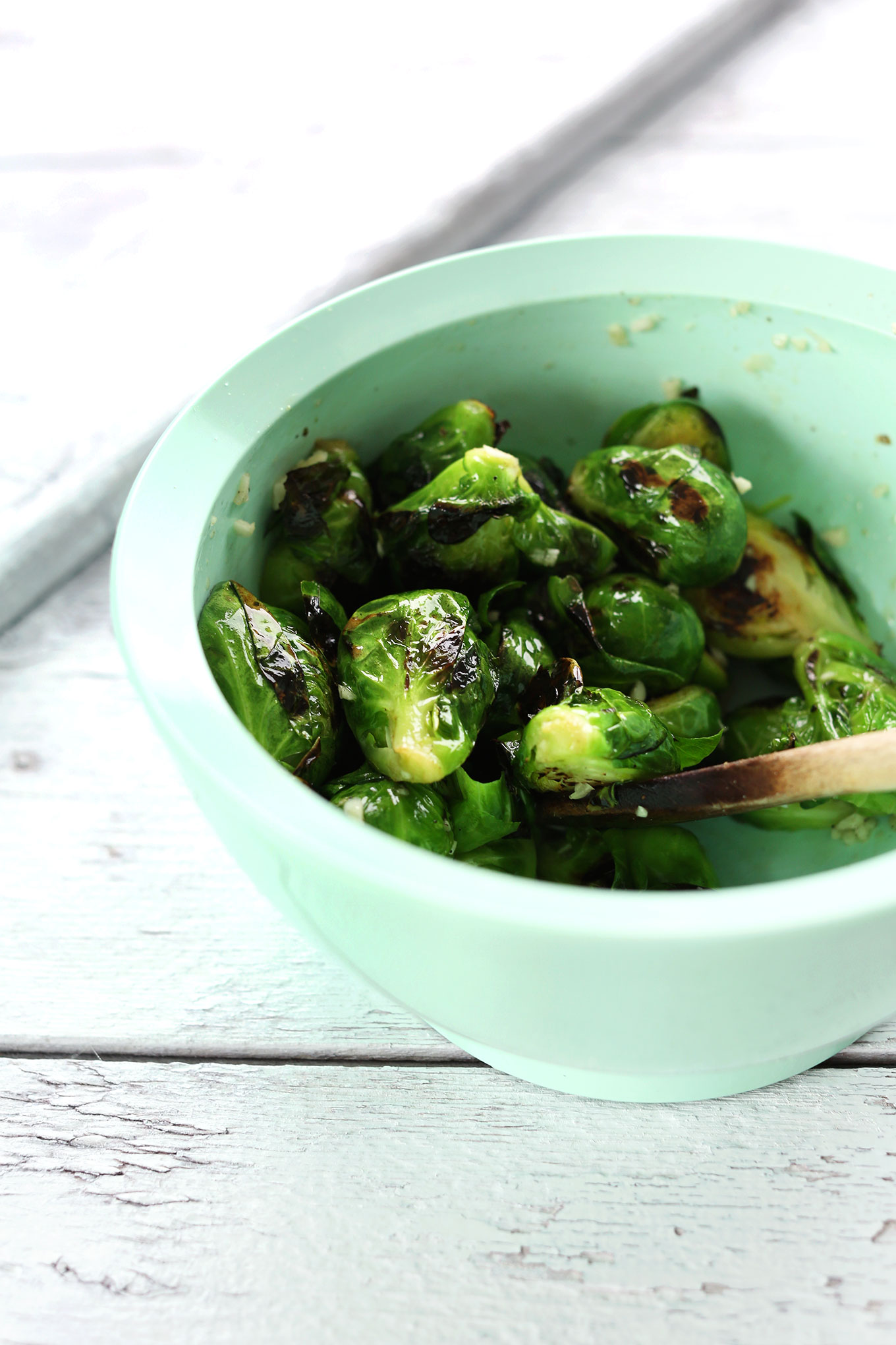 Mixing Brussels sprouts in avocado oil for our crispy Brussels Sprouts recipe