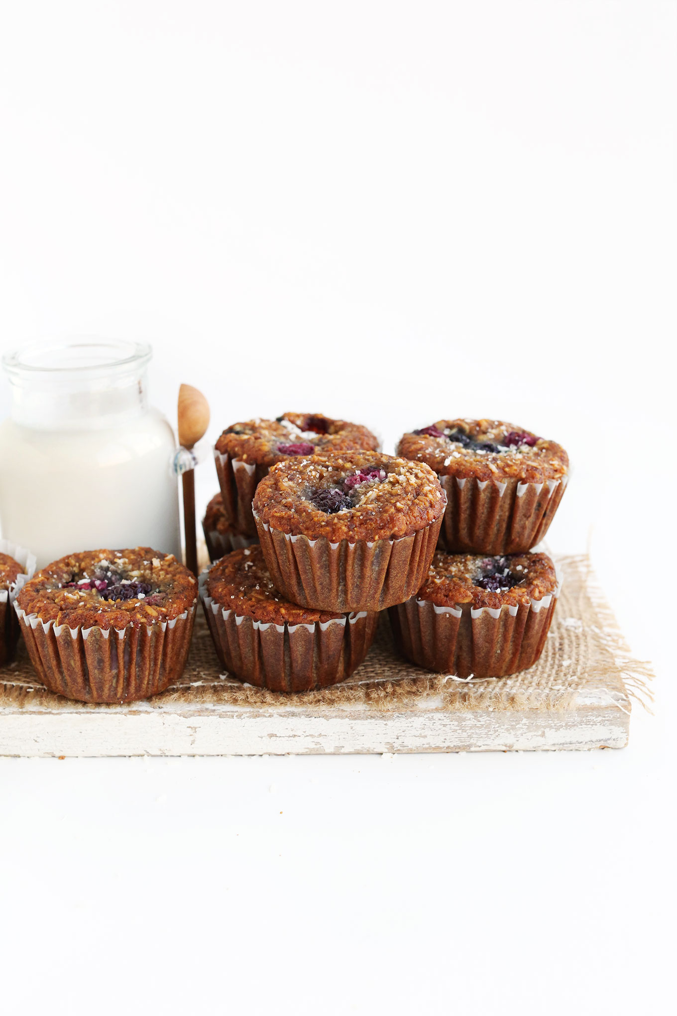 Wood board filled with a batch of our healthy Berry Coconut Muffins recipe
