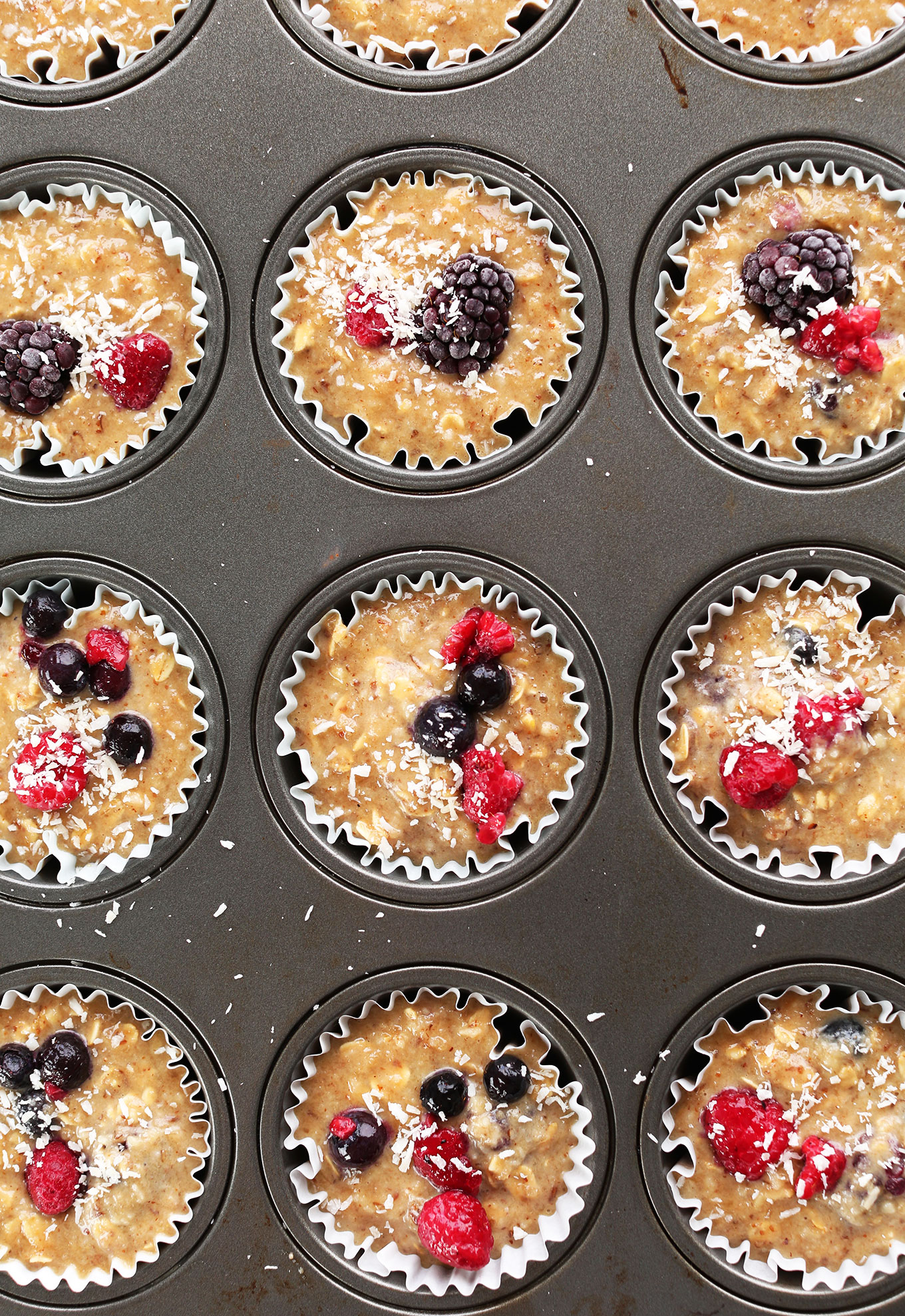 Muffin tin filled with our gluten-free vegan Berry Coconut Muffins recipe