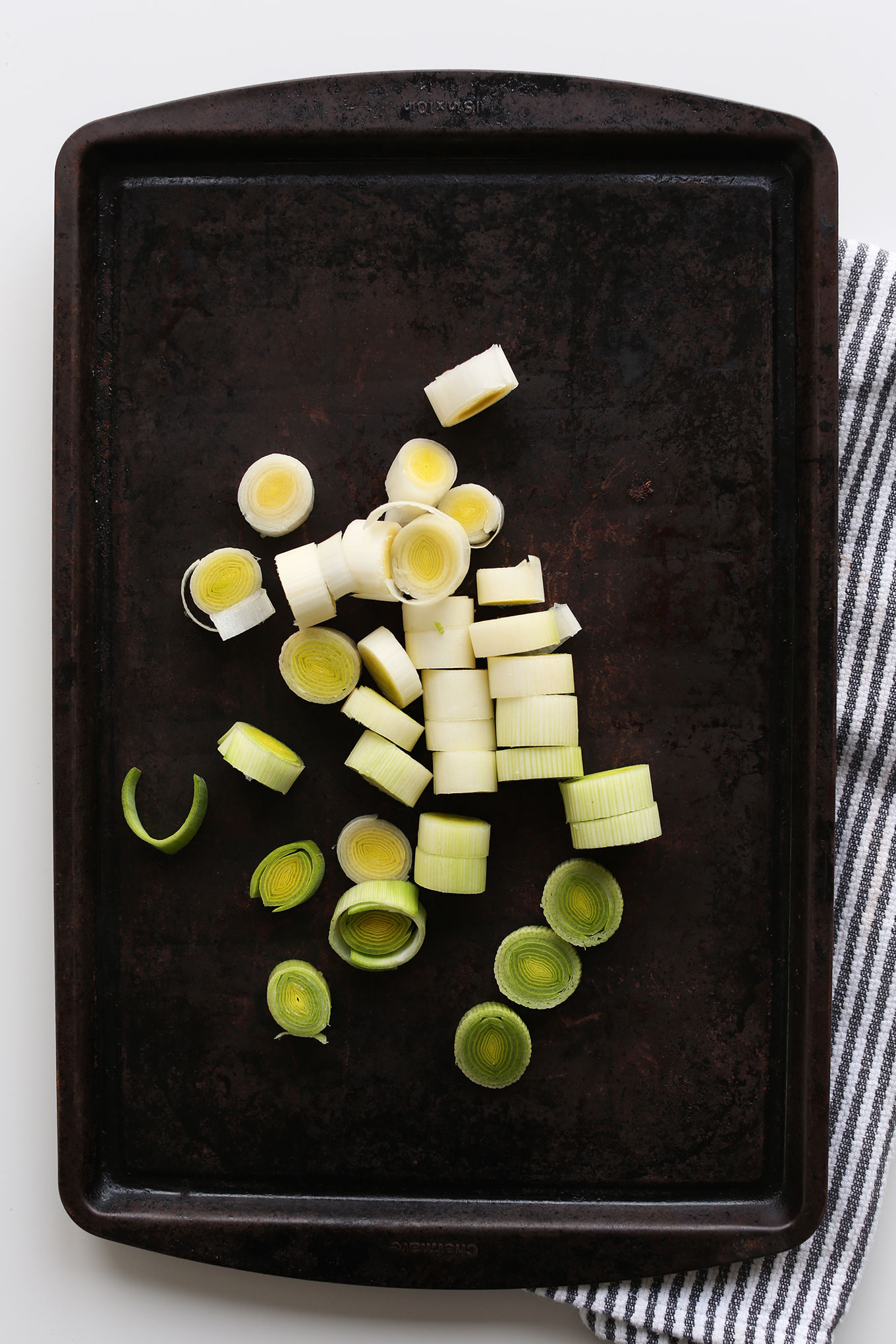 Roasting leeks on a baking sheet for a healthy vegan winter salad