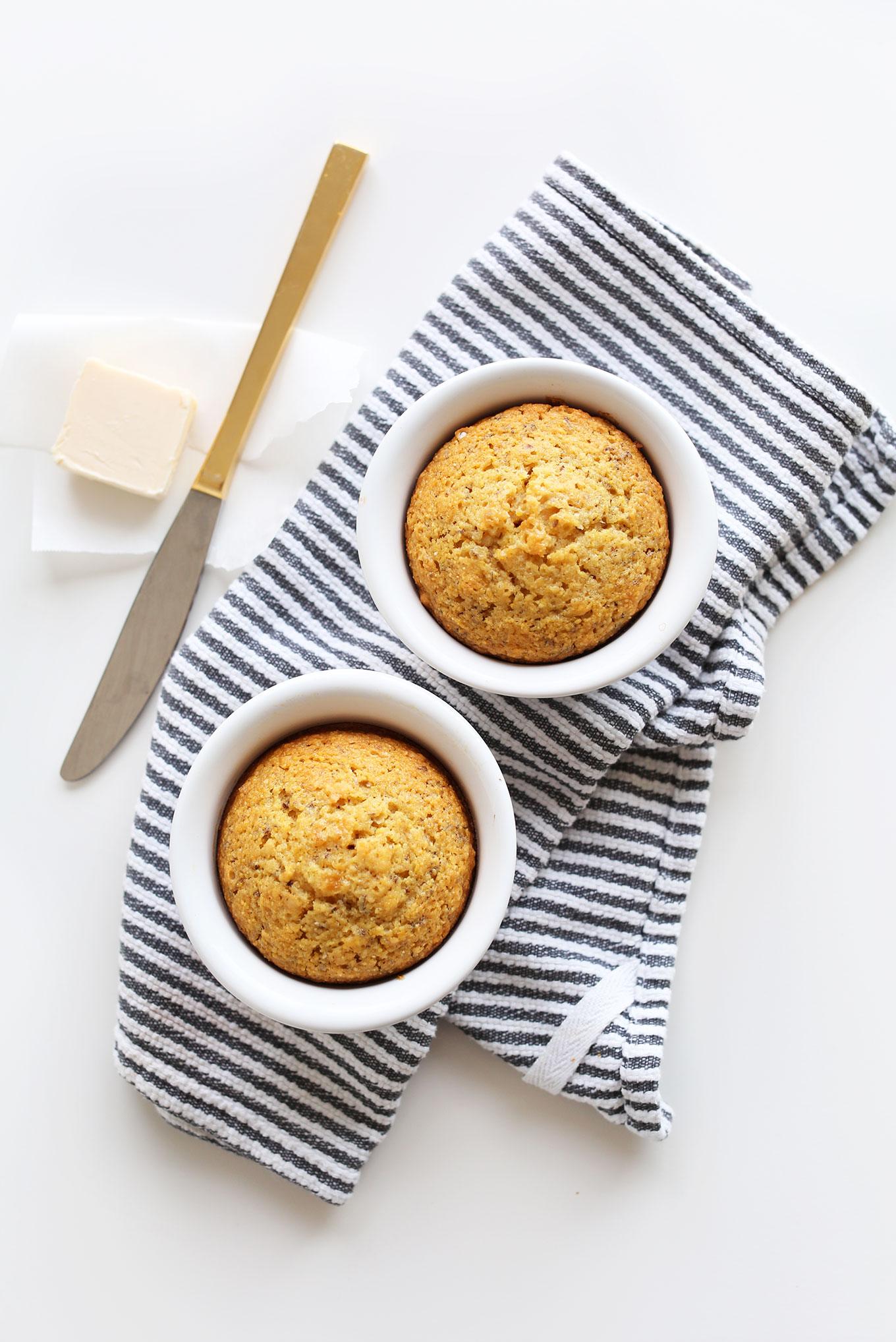 Freshly baked vegan cornbread muffins in ramekins