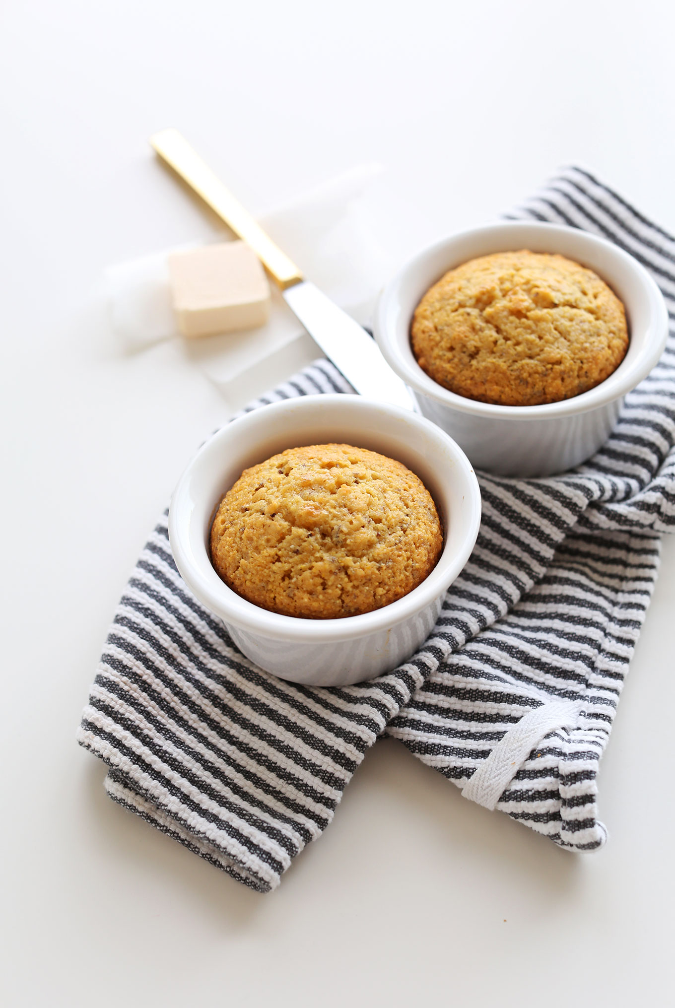 Two ramekins filled with sweet vegan cornbread