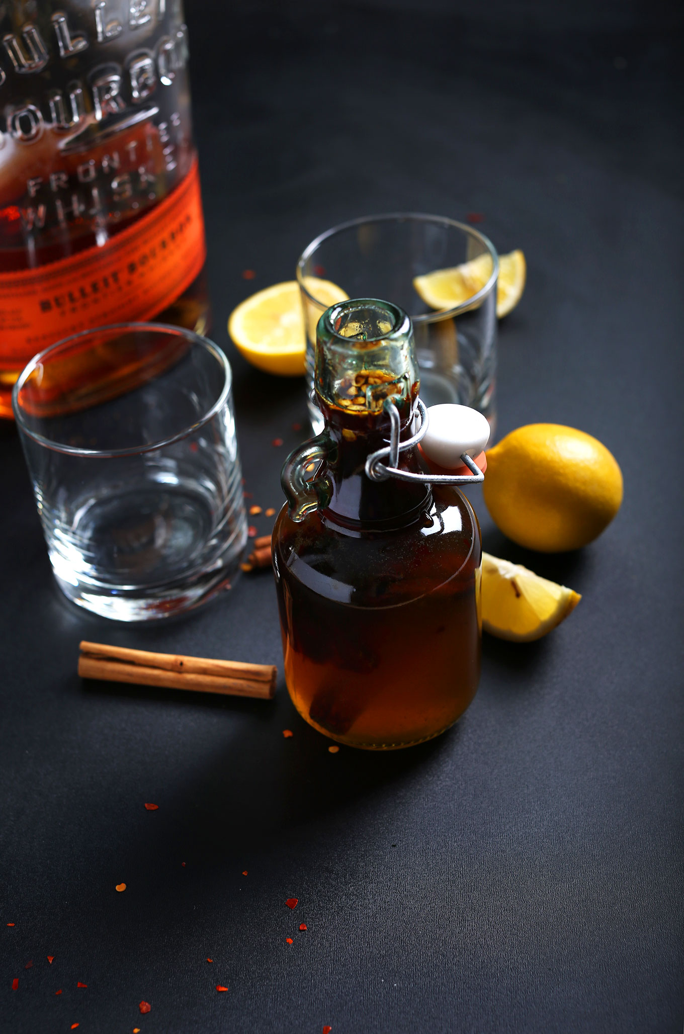 Spiced Cinnamon Simple Syrup and empty glasses ready for creating a delicious vegan drink