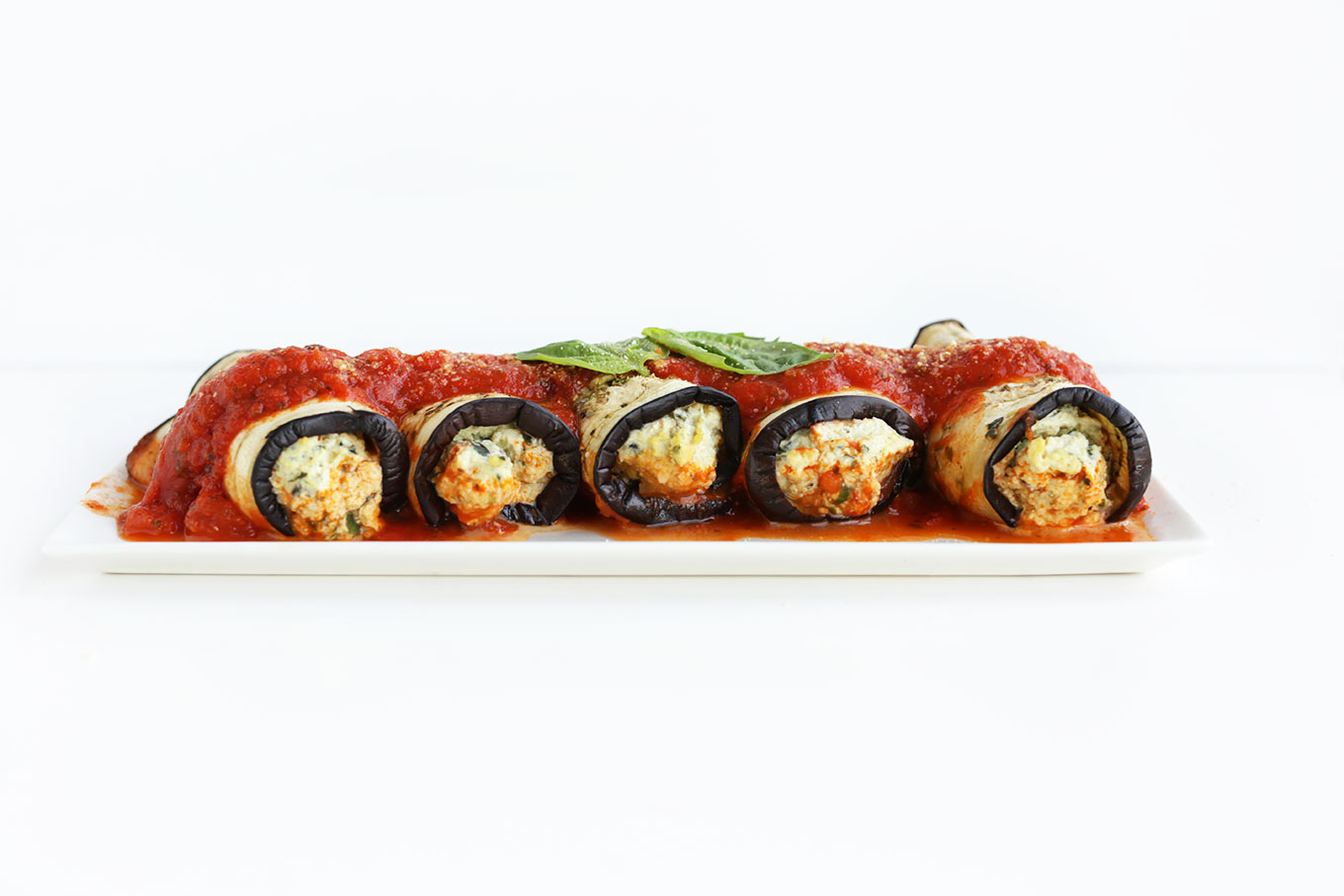 Side view of our Eggplant Lasagna Roll-Ups stuffed with Tofu Ricotta