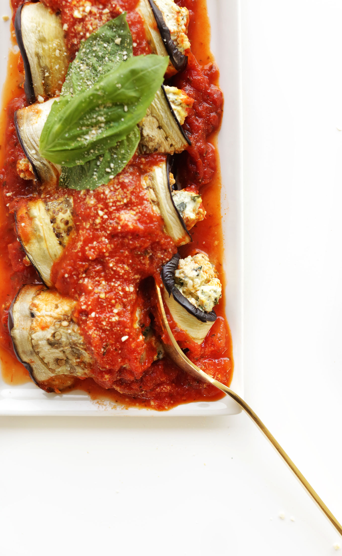 Using a fork to grab a bite of a delicious gluten-free vegan Eggplant Lasagna Roll-Up