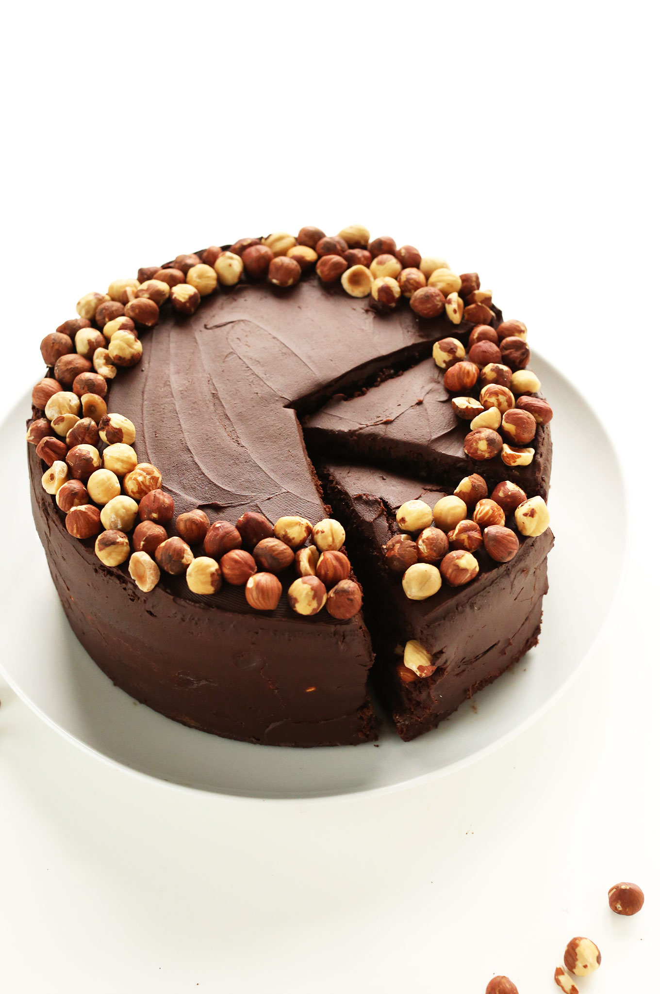 Grabbing slices of Chocolate Hazelnut Cake for a gluten-free vegan celebration