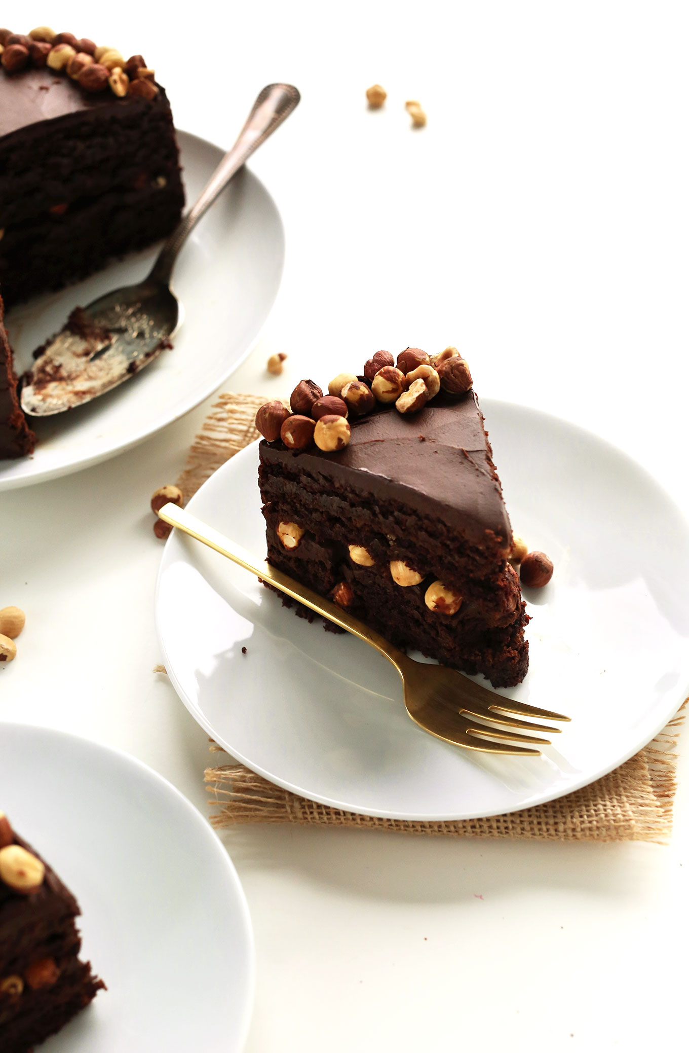 Plates of sliced Vegan Gluten-Free Chocolate Hazelnut Cake