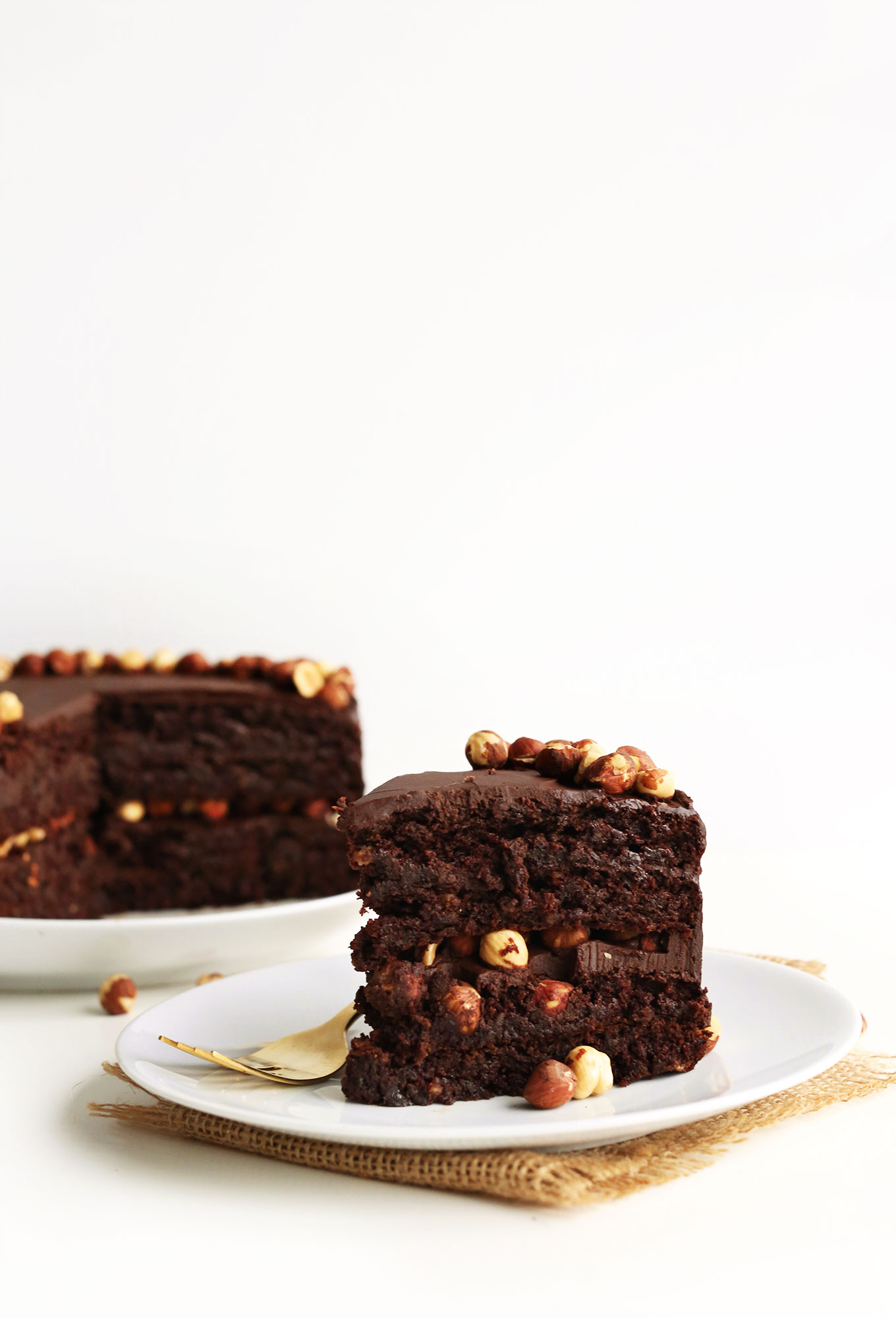 Slice of super rich gluten-free Vegan Chocolate Hazelnut Cake for dessert