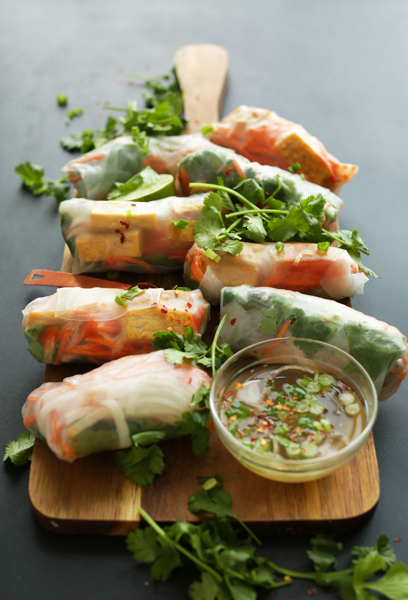 Wood cutting board filled with our gluten-free vegan Bahn Mi Spring Rolls recipe