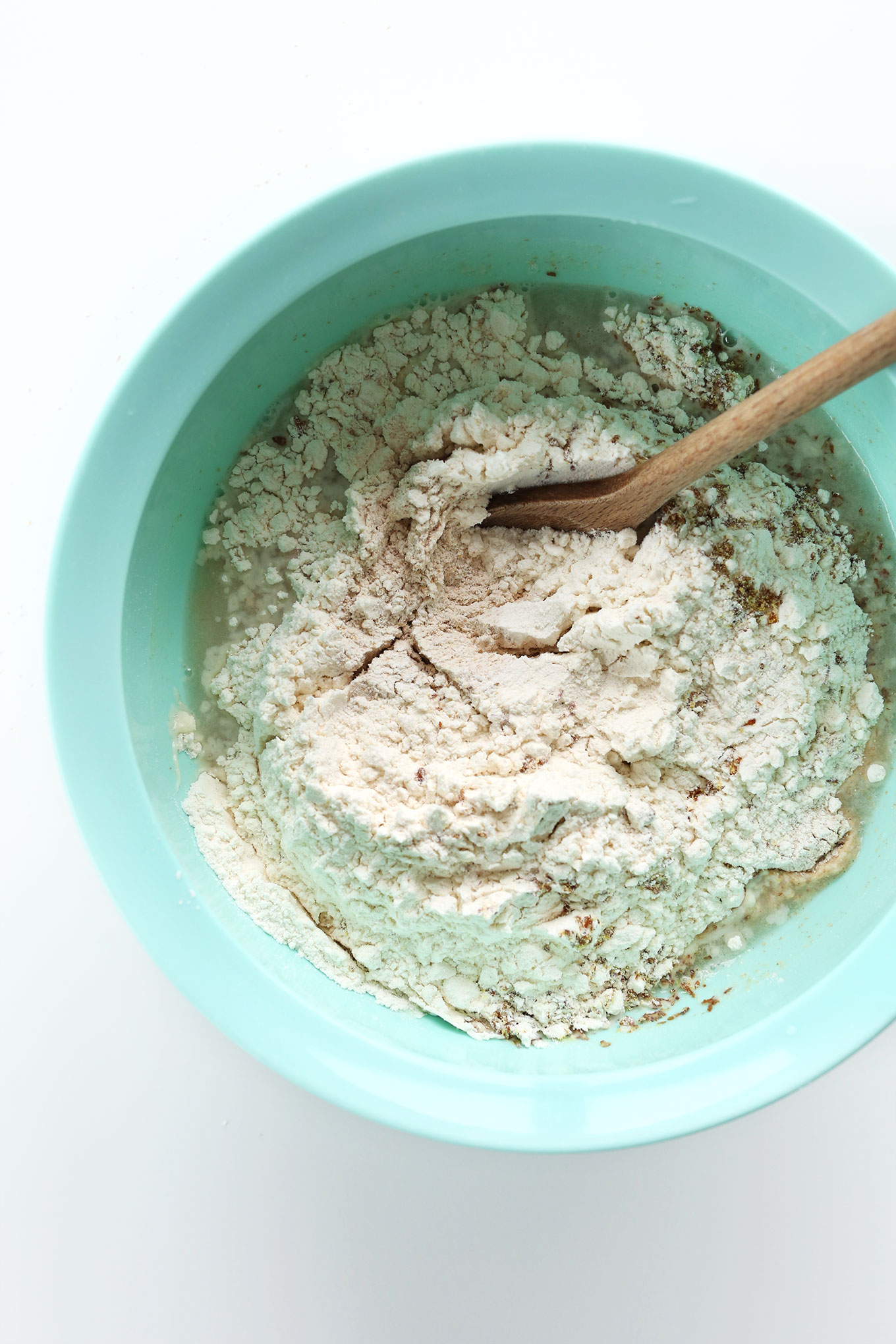 Mixing together ingredients for making easy Vegan Whole Grain Seeded Bread