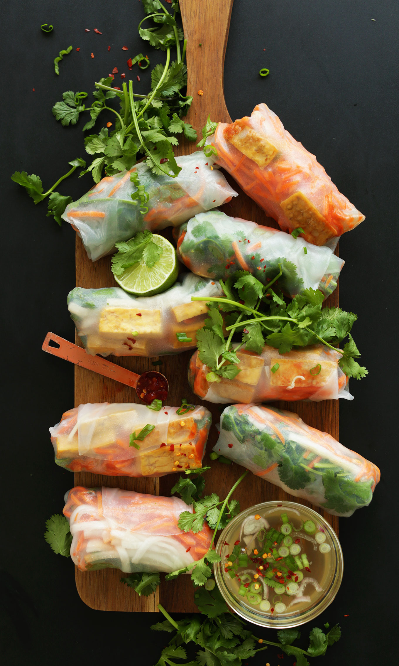 Wood cutting board with fresh and satisfying Bahn Mi Spring Rolls