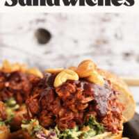 BBQ jackfruit sandwiches on whole wheat buns with avocado slaw and cashews