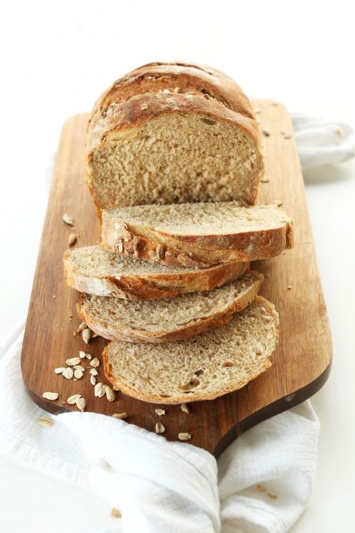 Sliced easy homemade Whole Grain Vegan Bread on a cutting board