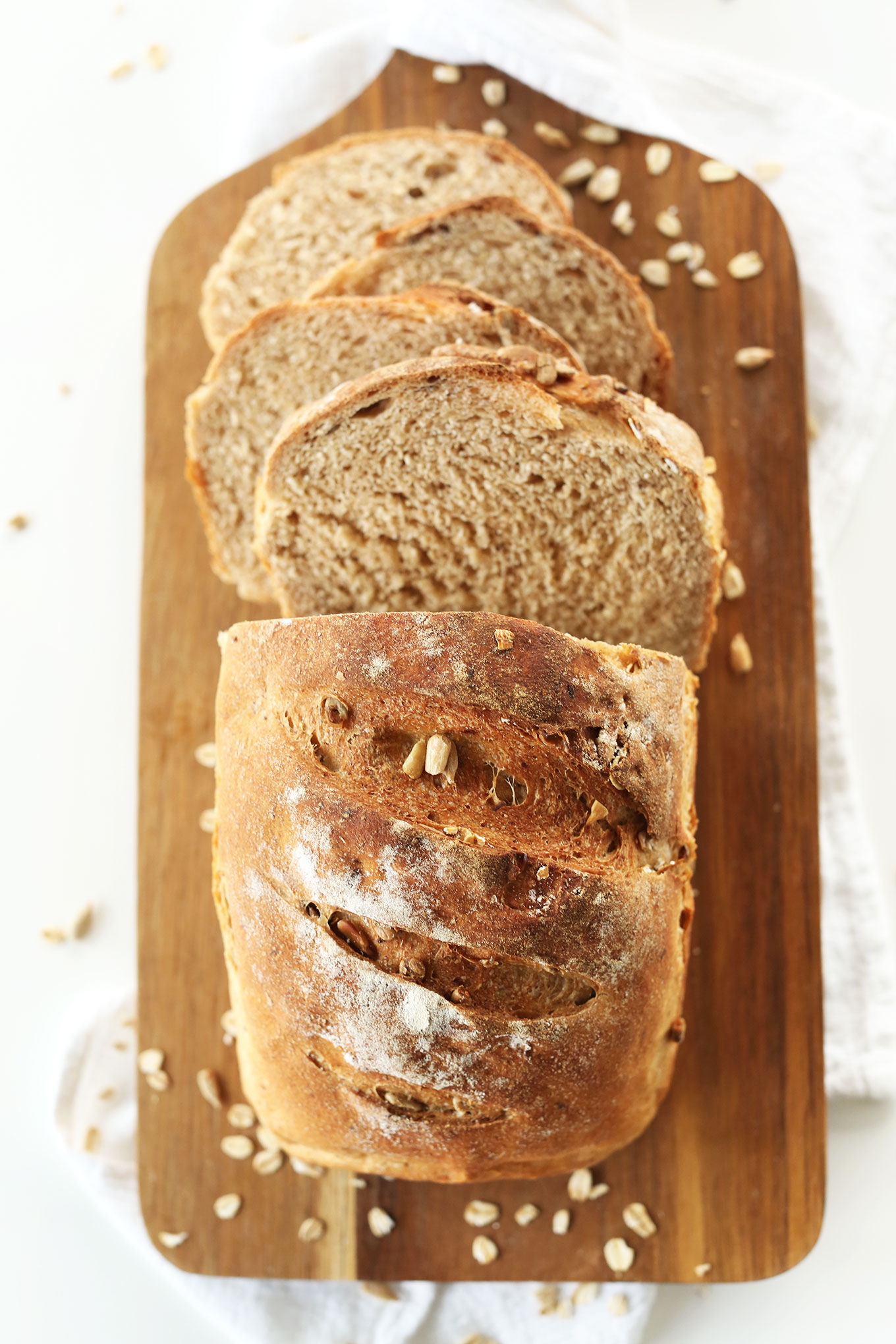 Partially sliced loaf of our homemade Seedy Vegan Bread recipe