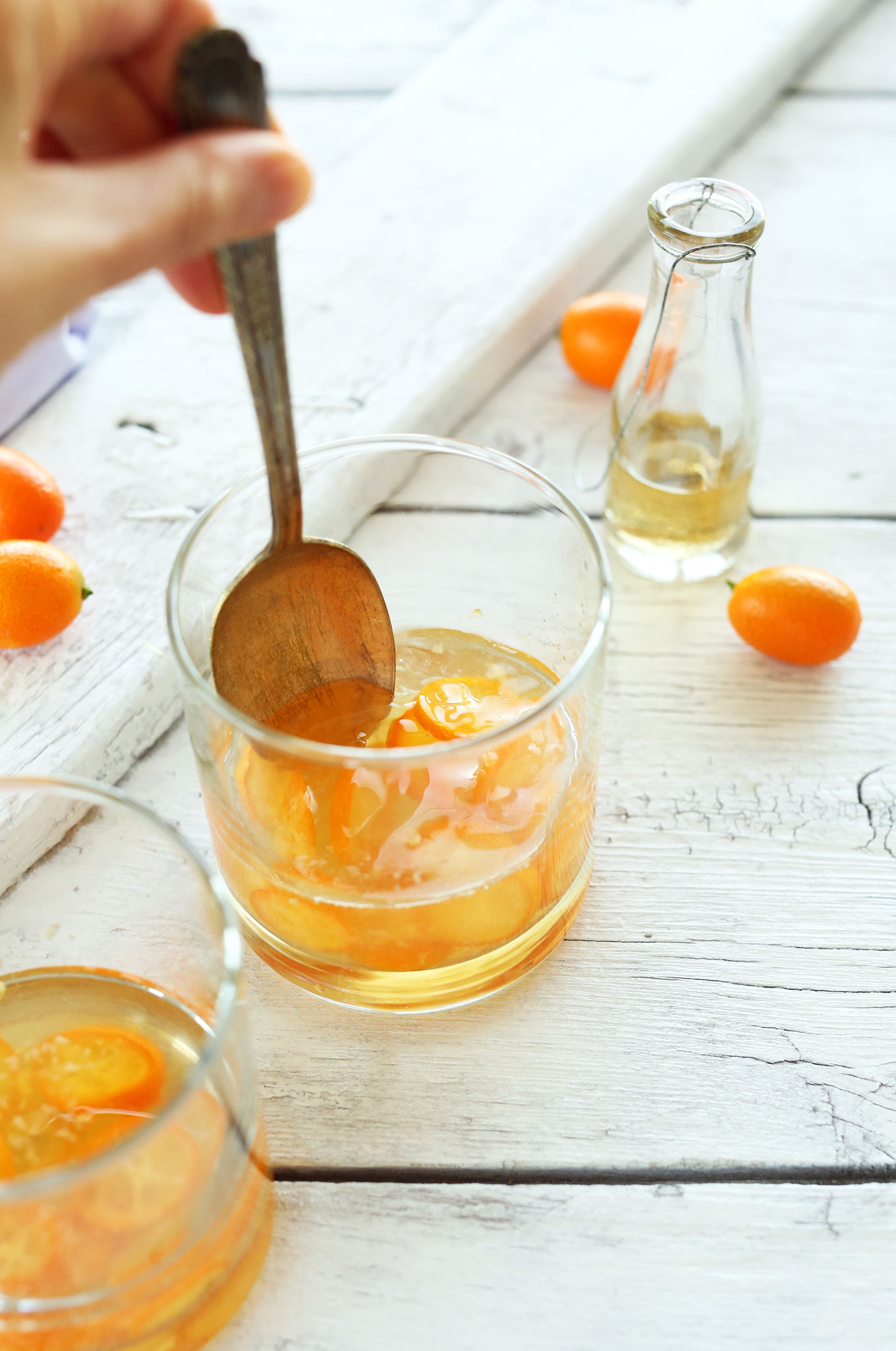 Using a spoon to mix a homemade Fresh Citrus Gin and Tonic