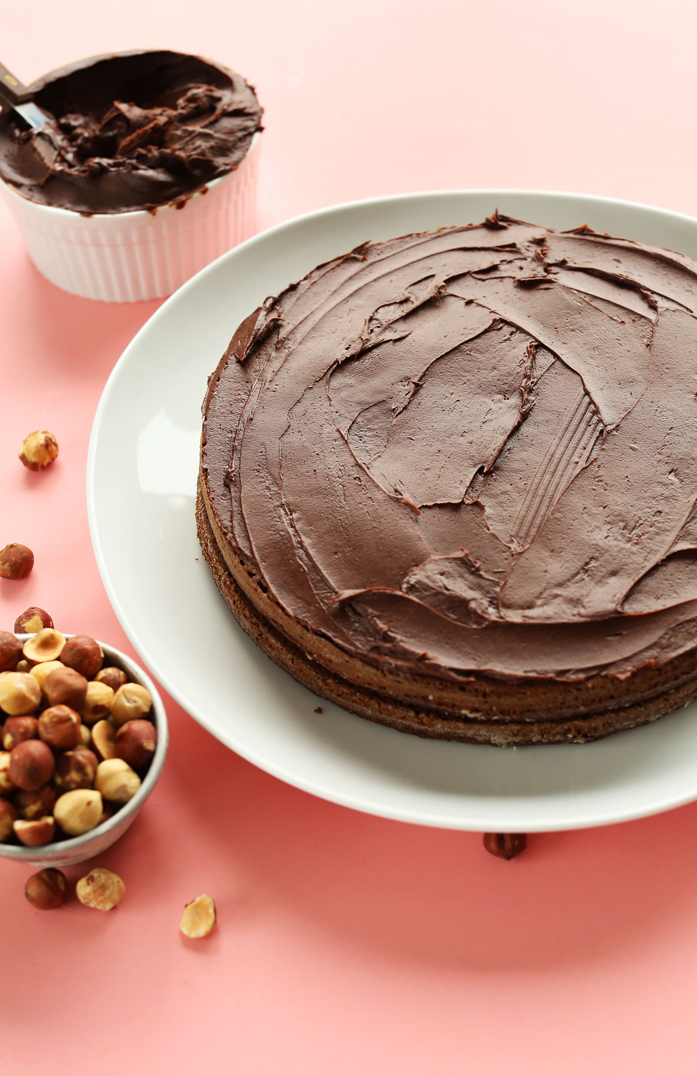 Two layers of our gluten-free vegan Chocolate Hazelnut Cake recipe with rich chocolate frosting