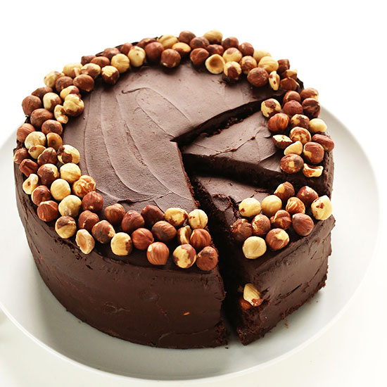 Partially sliced plate of Vegan GF Chocolate Hazelnut Cake