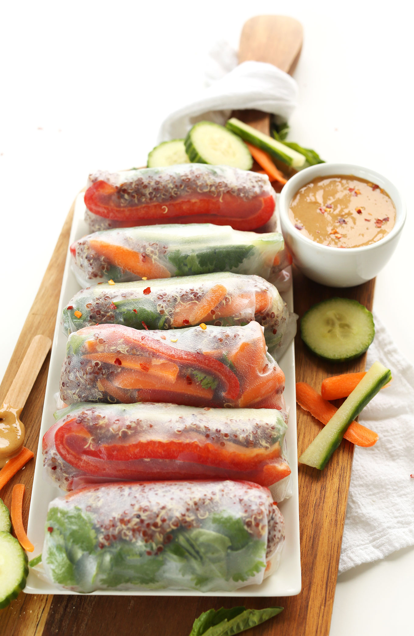 Platter of gluten-free vegan Quinoa Spring Rolls with a bowl of Cashew Dipping Sauce
