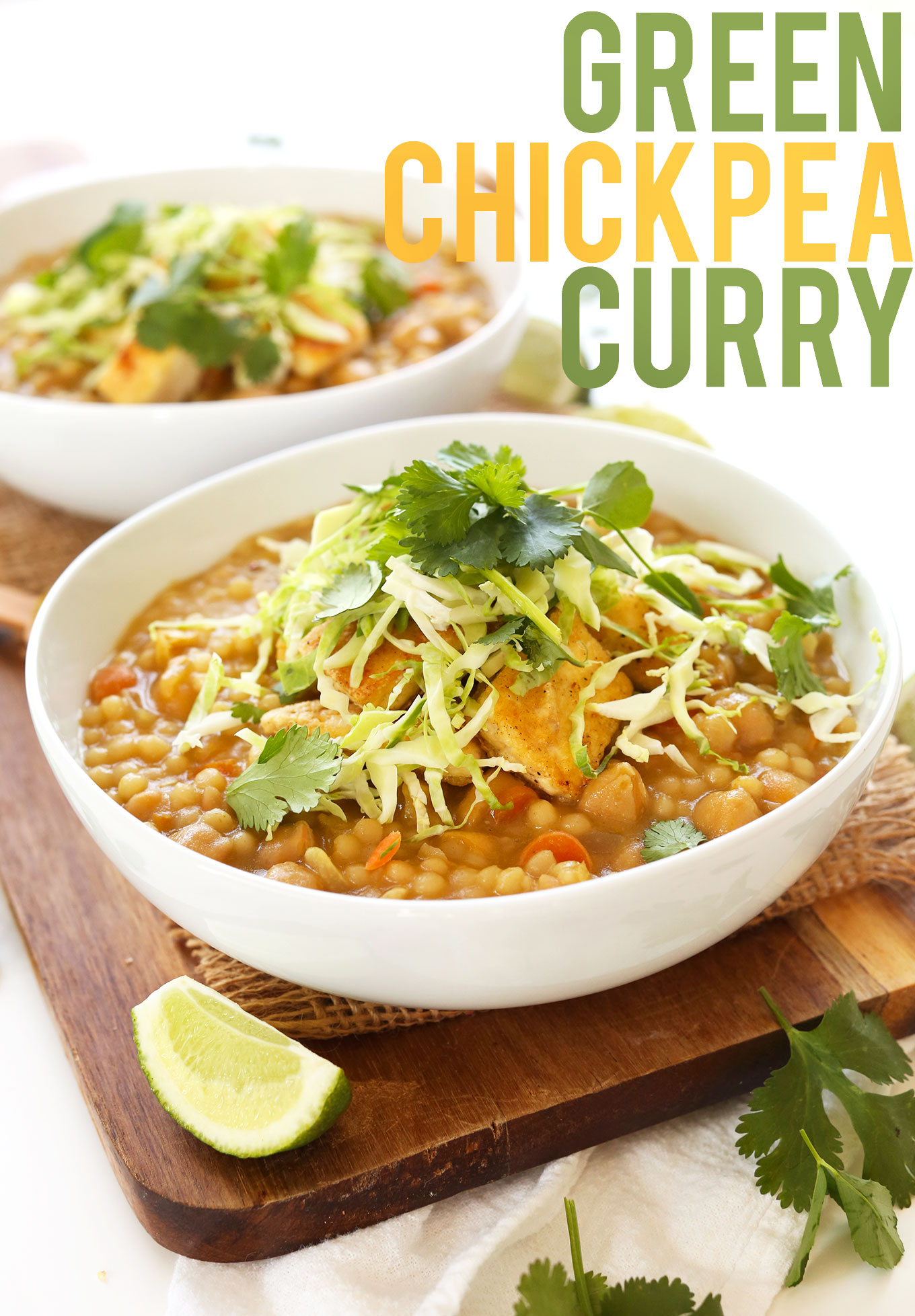 Bowls of Green Chickpea Curry topped with fresh cabbage and cilantro for a satisfying vegan dinner