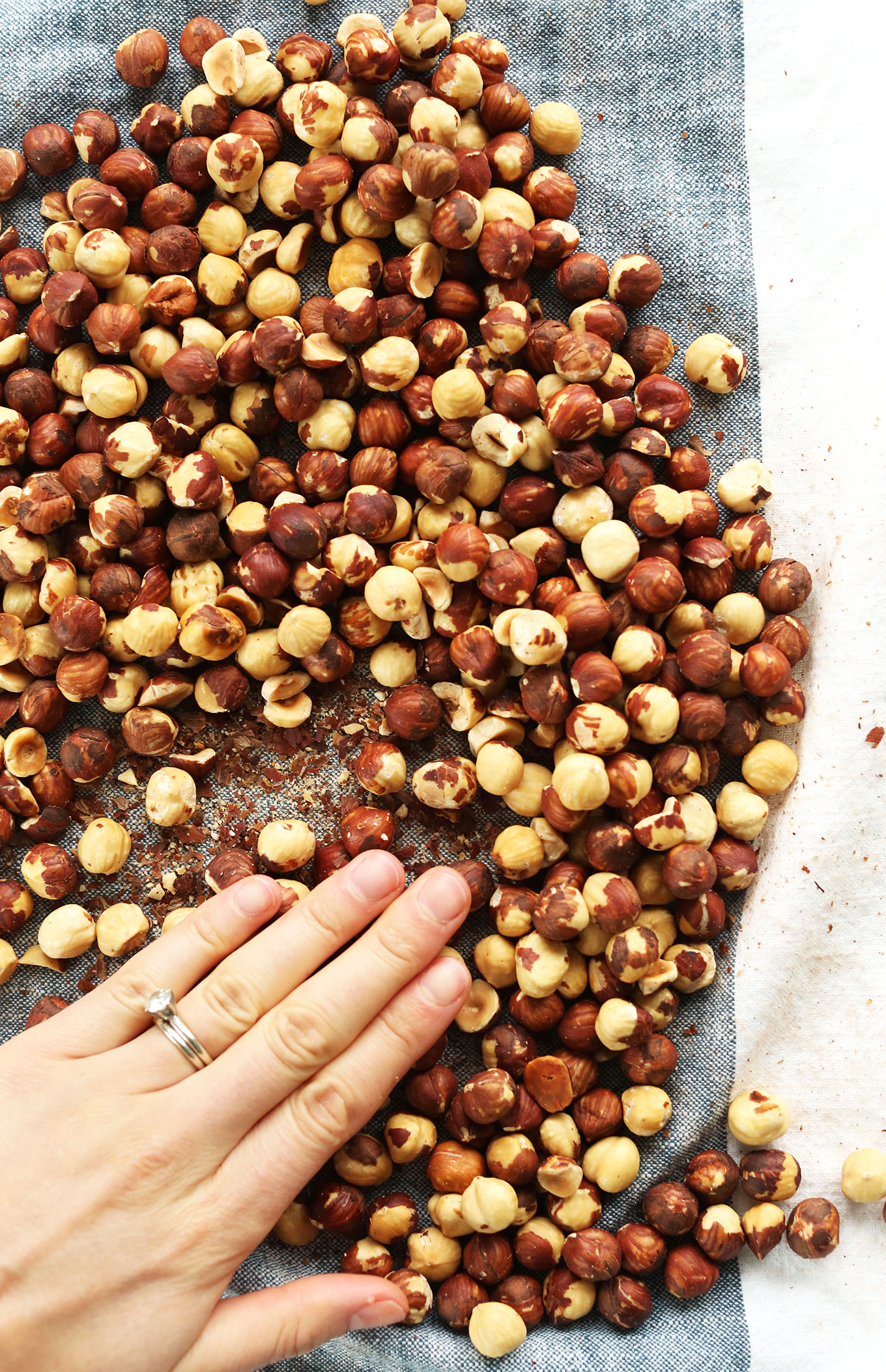 Rolling roasted hazelnuts in a towel to remove skins