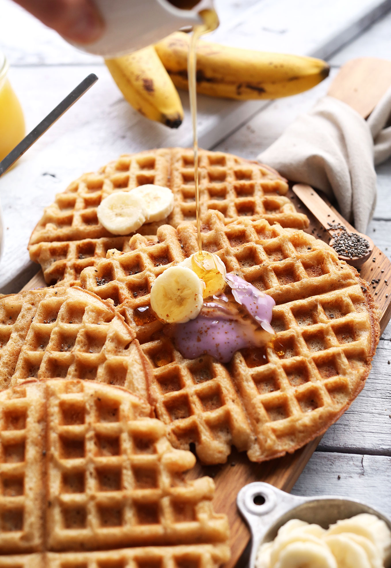 Pouring syrup onto a Vegan GF Yogurt Waffle