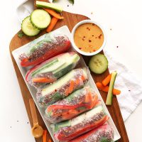 Platter of Quinoa Spring Rolls alongside a bowl of Cashew Dipping Sauce