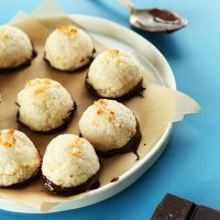 Parchment-lined plate of Vegan Dark Chocolate Coconut Macaroons