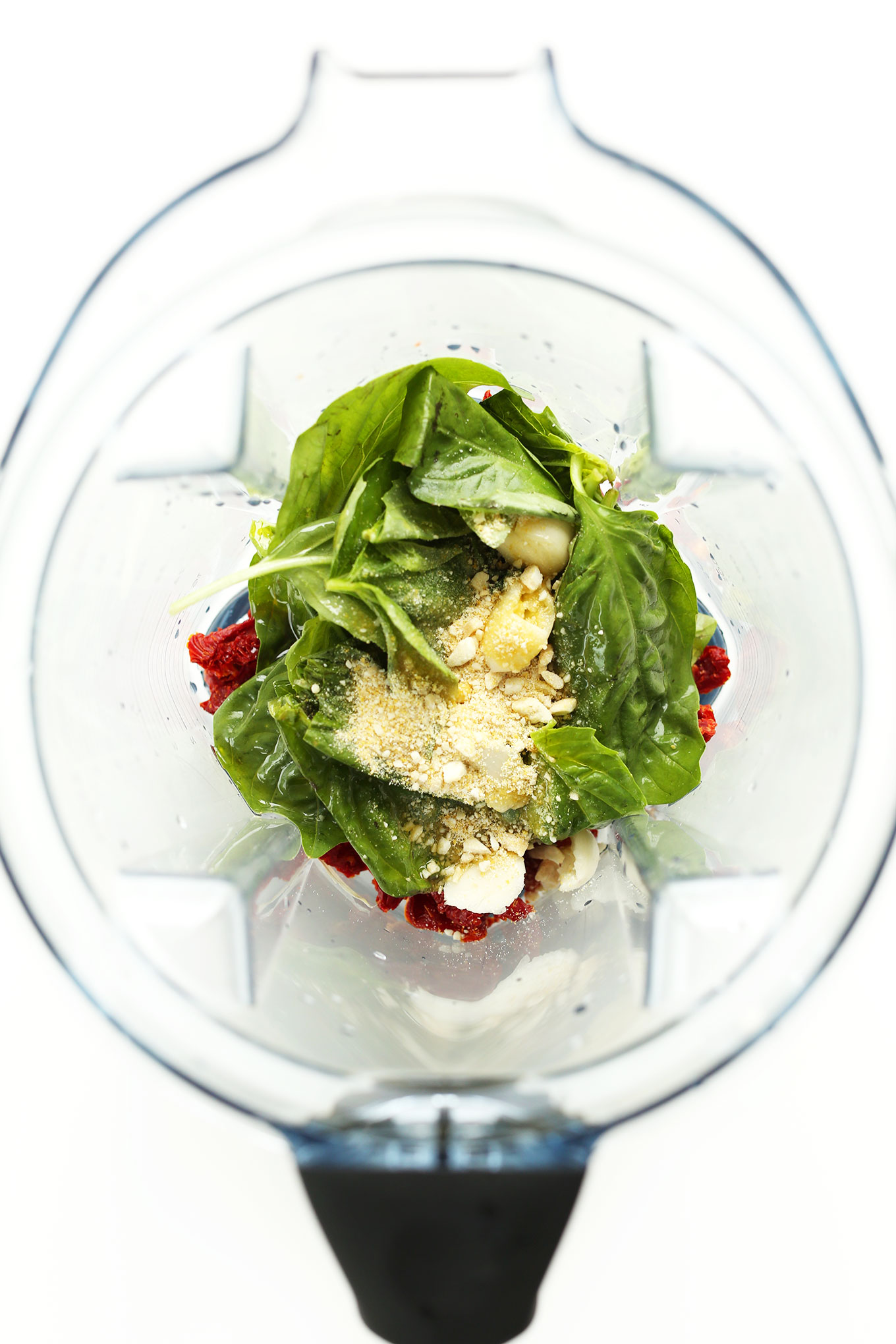 Blender with ingredients for making Vegan Sun-Dried Tomato Pesto