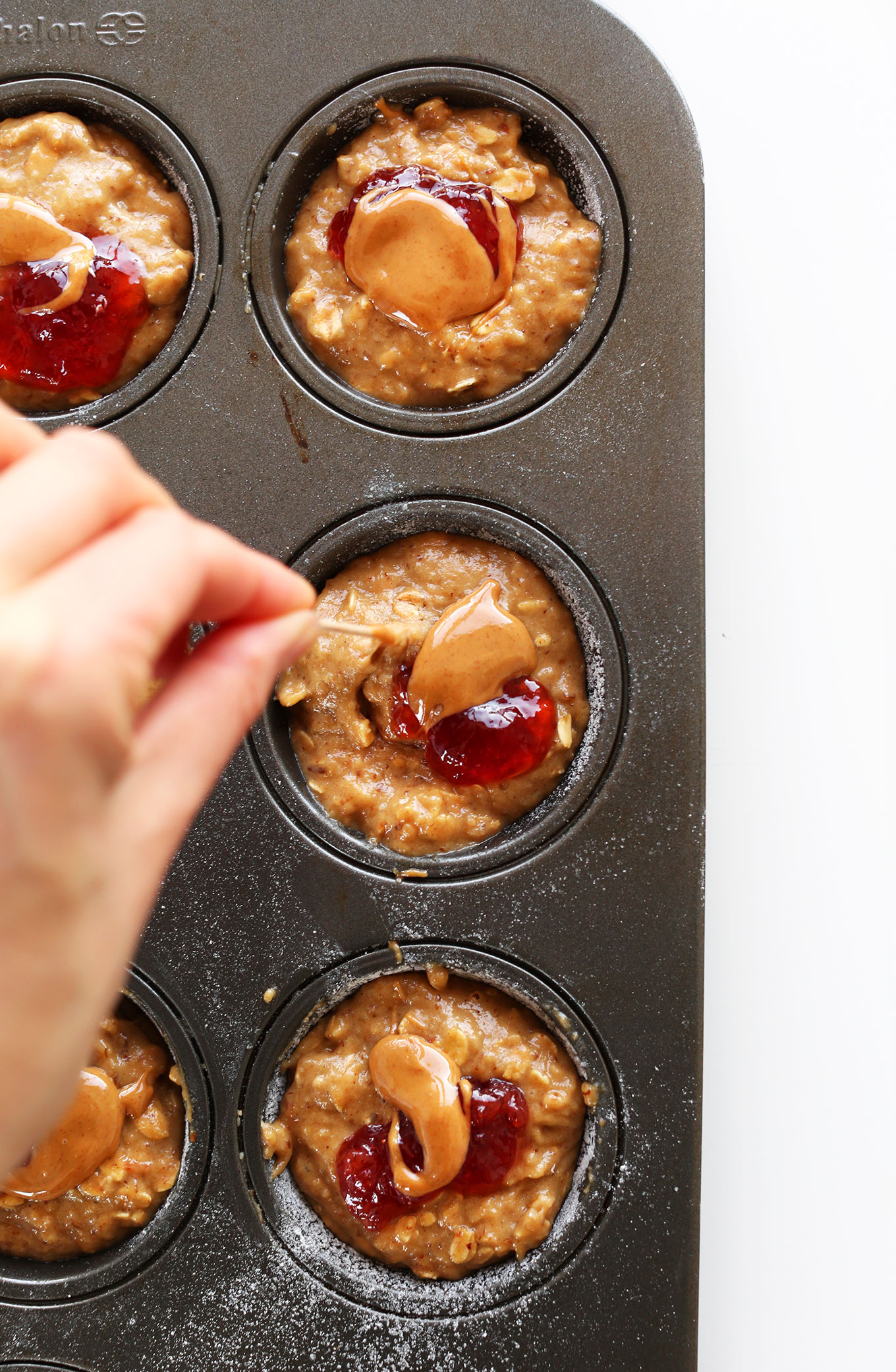 Using a toothpick to make a swirl of peanut butter and jelly
