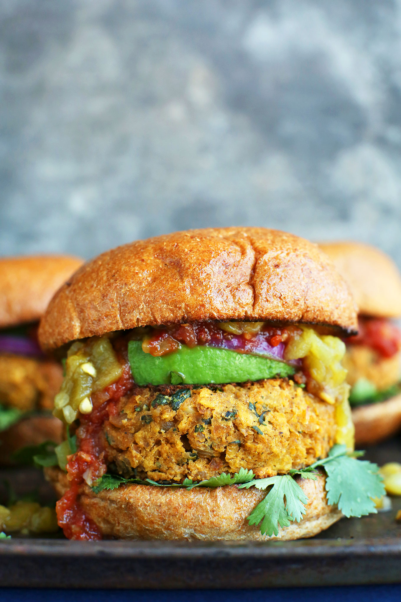 Gluten-free vegan Green Chili Veggie Burgers on buns with delicious toppings