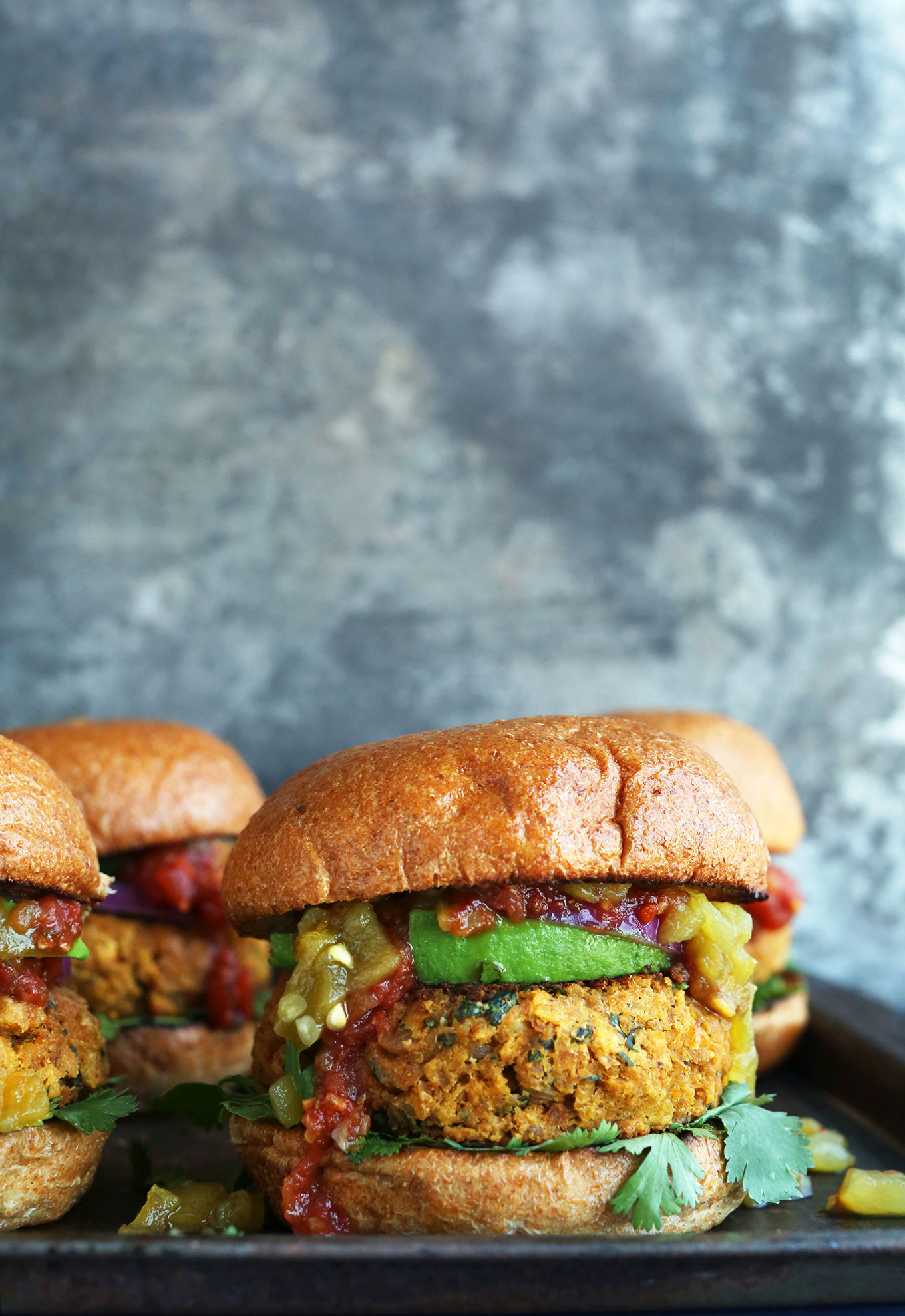 Plate of homemade gluten-free Green Chili Veggie Burgers for a vegan Mexican-style dinner