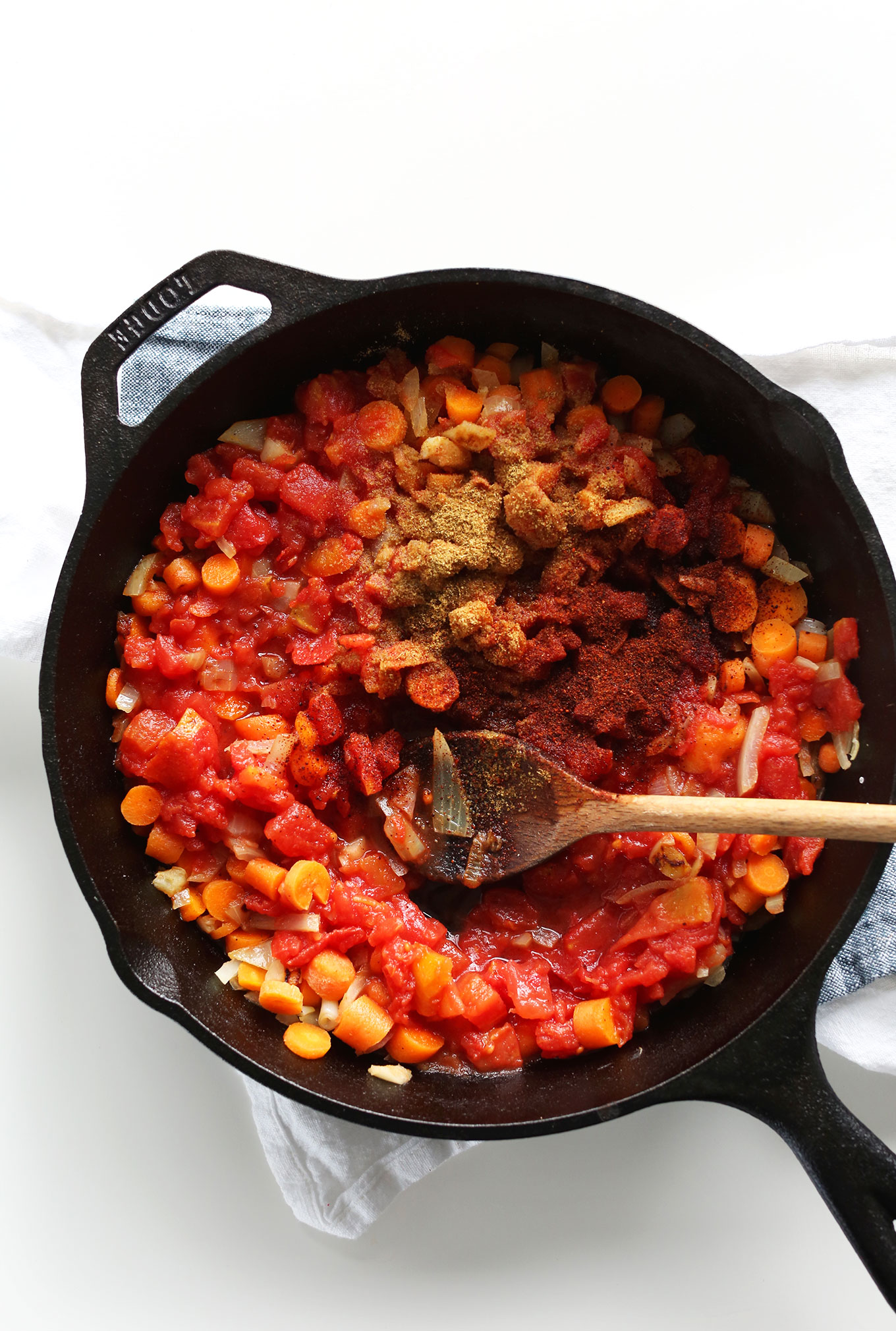 Cast iron skillet with ingredients for making homemade Chipotle Blended Red Salsa